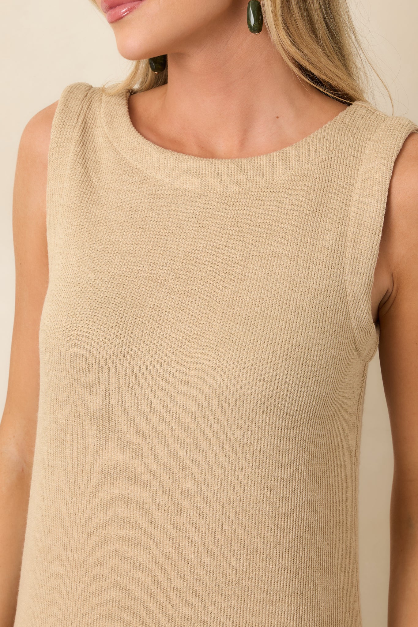 Close detail of the natural rib knit fabric highlighting its soft texture and rounded neckline.