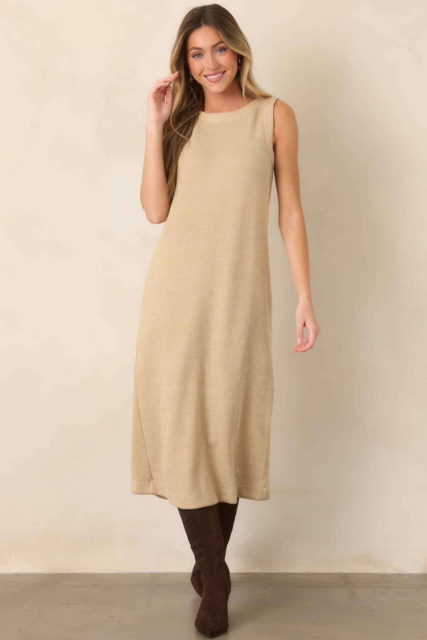 Natural-toned knit dress with a clean sleeveless silhouette, subtle vertical ribbing, and an effortlessly refined midi length.