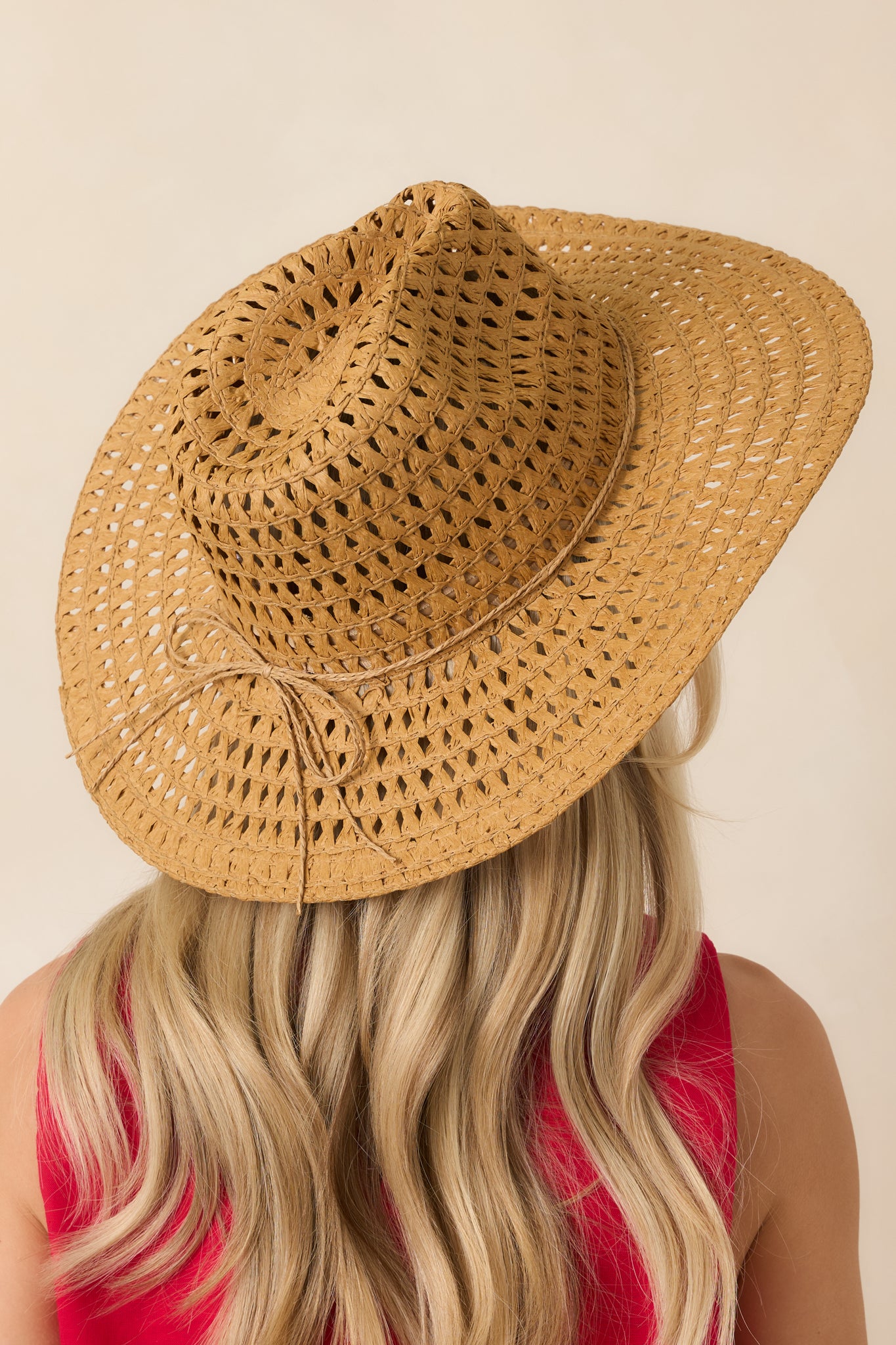 Back view of the natural straw cowboy hat highlighting the breathable woven texture and classic wide brim shape.