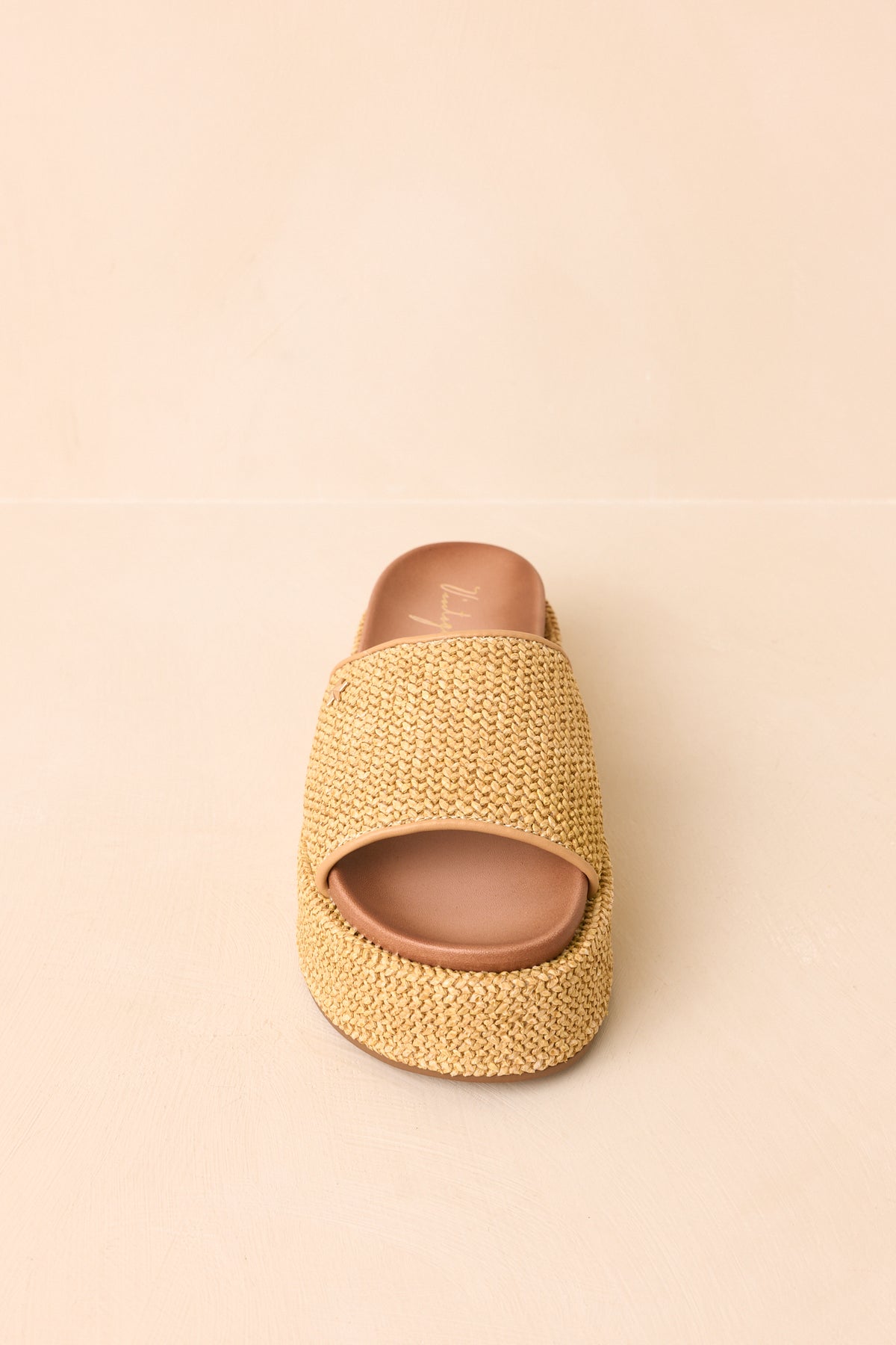 Natural-hued sandals showcasing the wide woven straps and open-toe silhouette.
