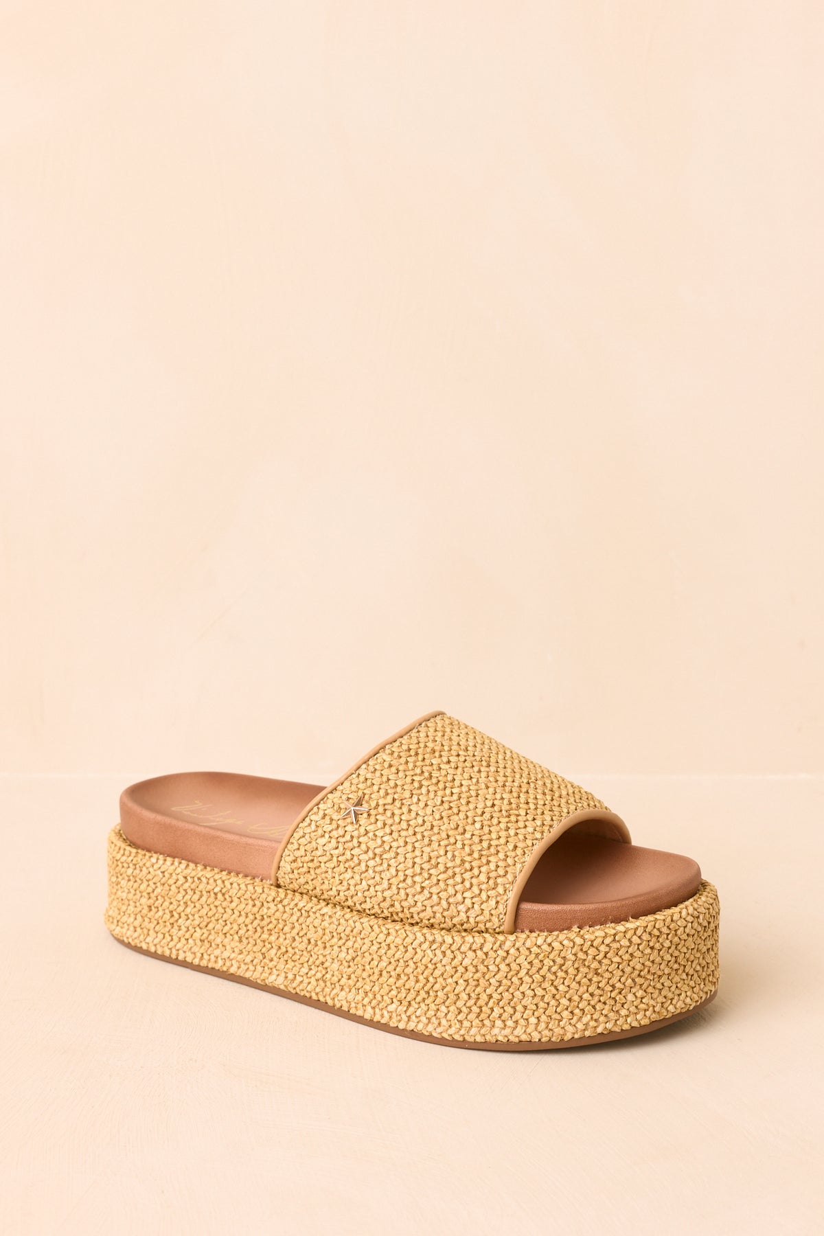 Slip-on sandals with natural woven straps, tan trim, and elevated platform soles.
