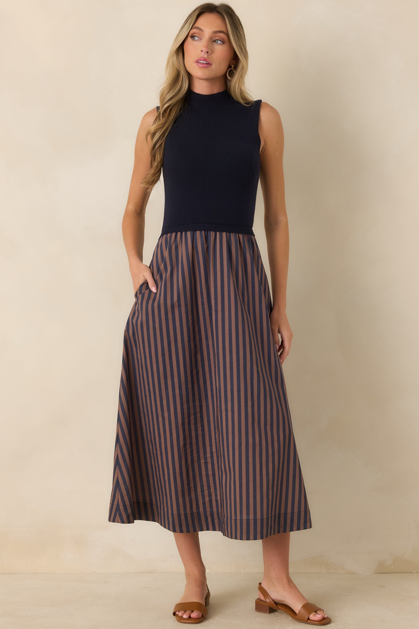 Nautical-inspired midi dress crafted with a sleeveless design, mock neckline, and a flattering A-line silhouette.
