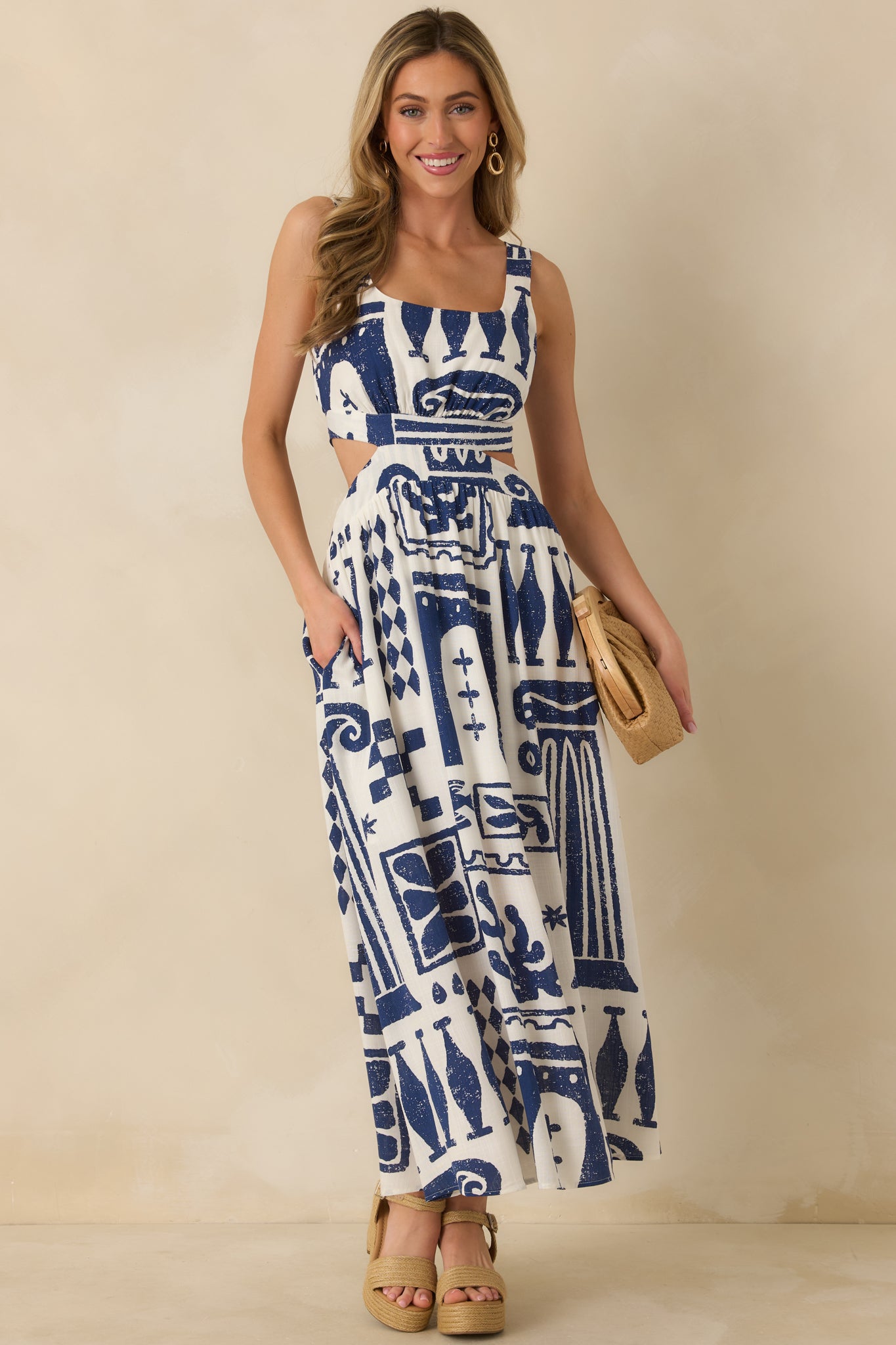 Navy and white woven maxi with structured bodice, wide straps, and softly draped skirt to the hem.