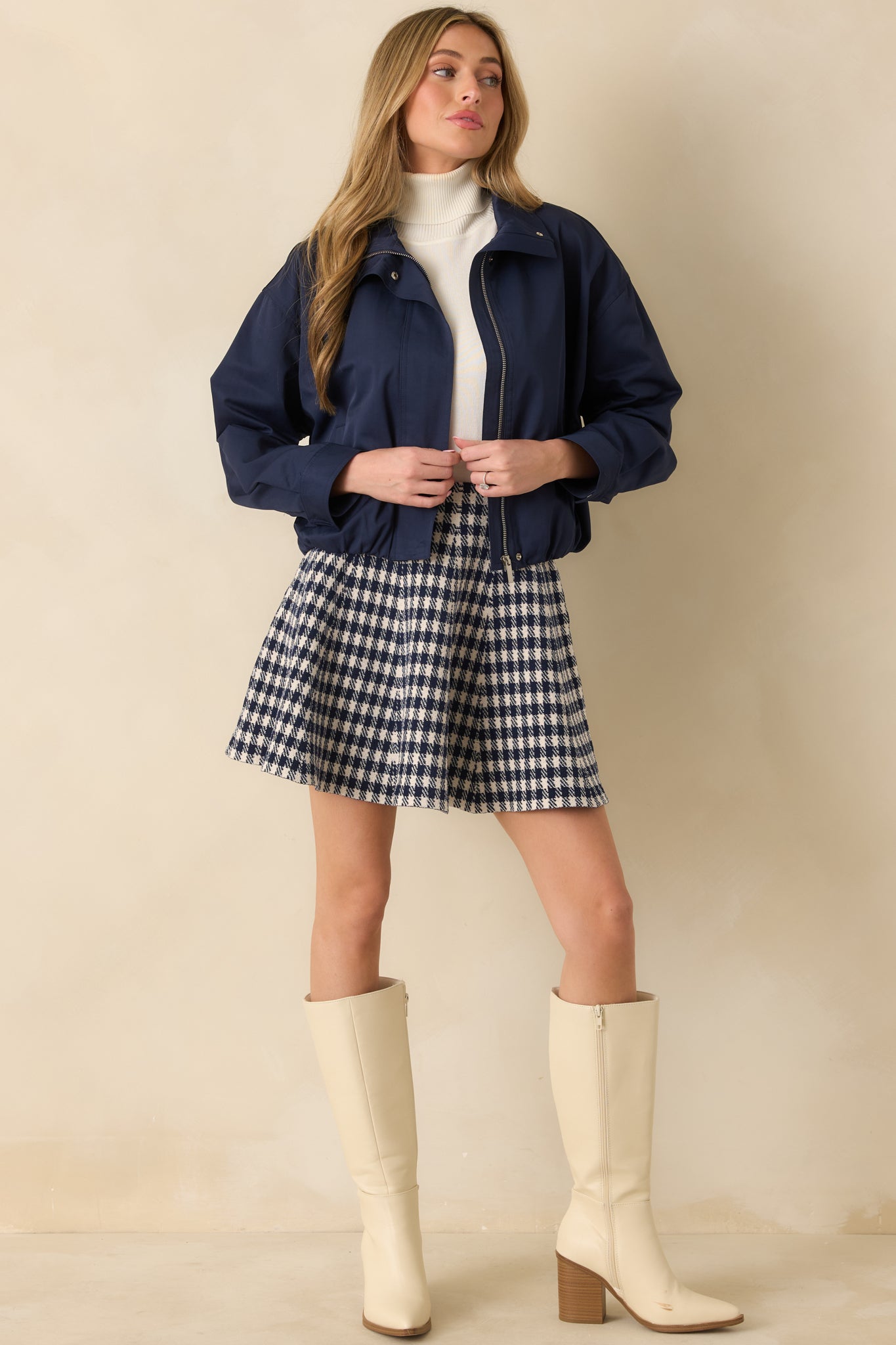 Front view of navy bomber jacket with zip closure, stand collar, and relaxed cropped silhouette.