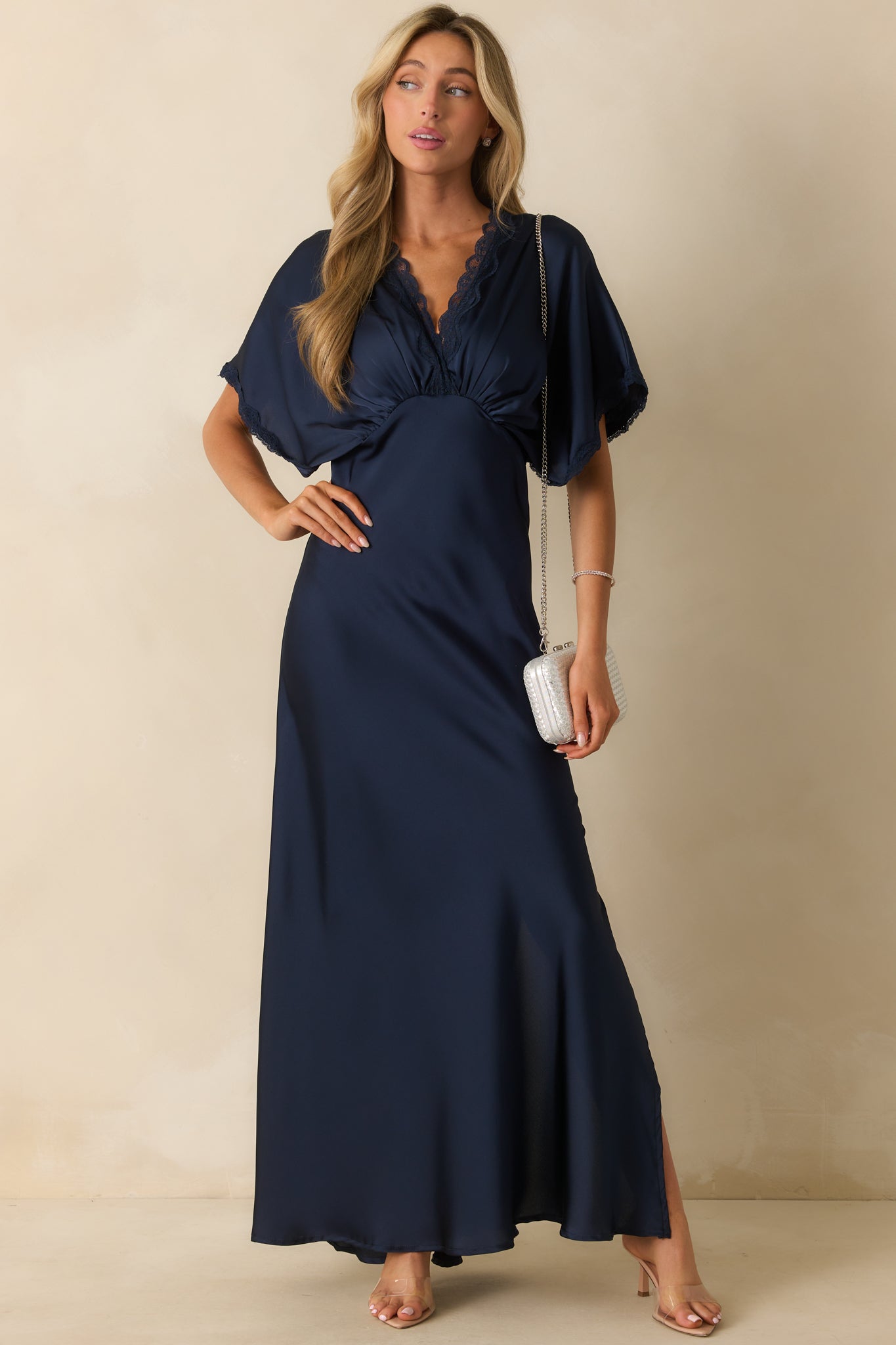 Sleek navy dress featuring a v-neckline, gathered bust, and side slit for a subtle draped effect.