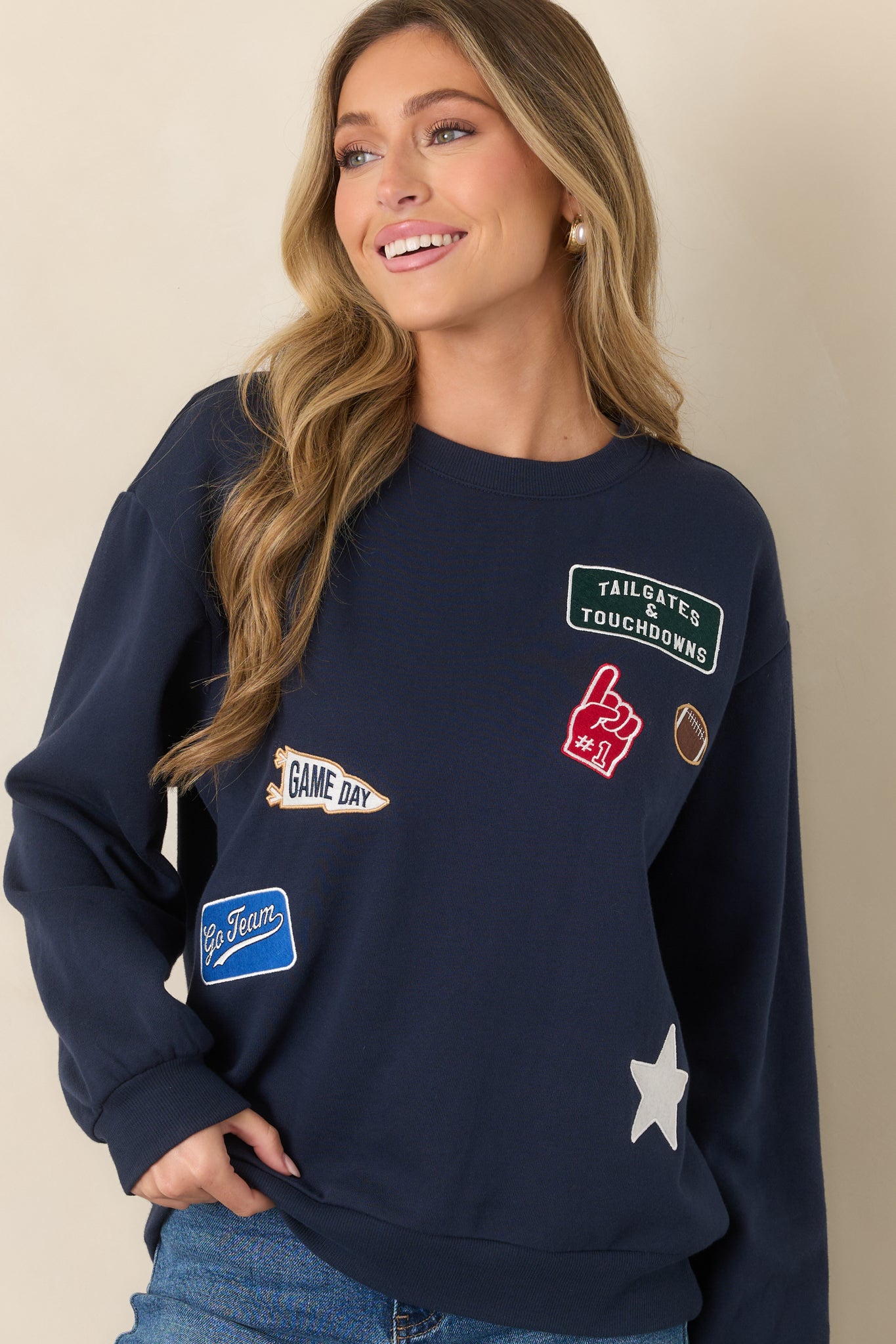 Relaxed navy sweatshirt highlighting its dropped shoulder seams, roomy sleeves, and ribbed crew neckline.