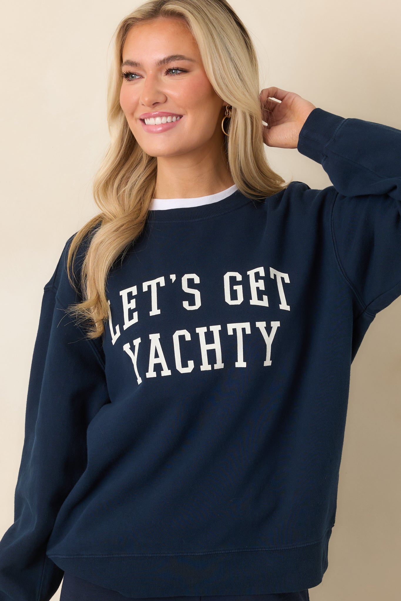 Close cropped view emphasizing the bold white collegiate print on navy fabric.