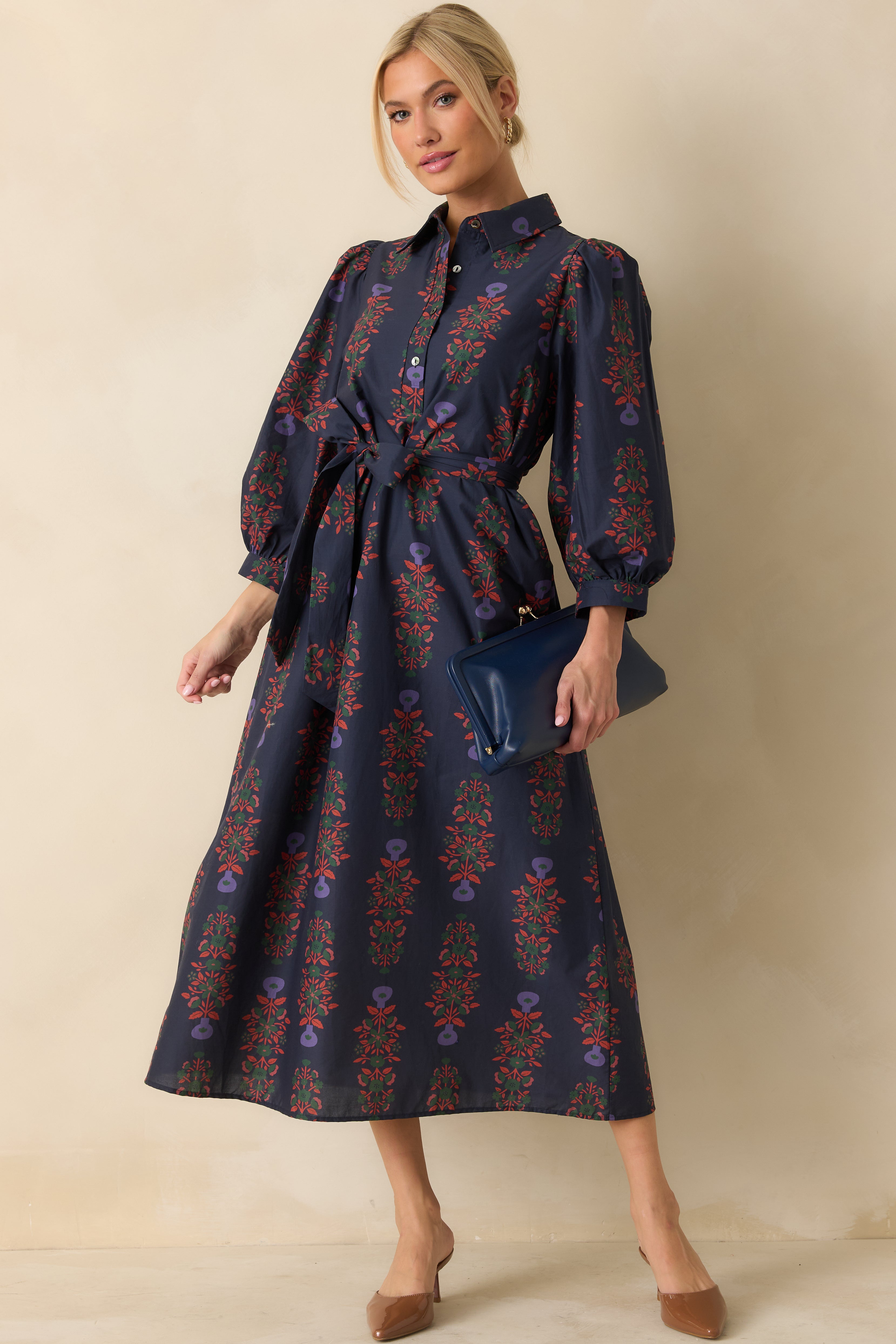 Navy floral cotton maxi dress with collared neckline, front buttons, and puff sleeves.