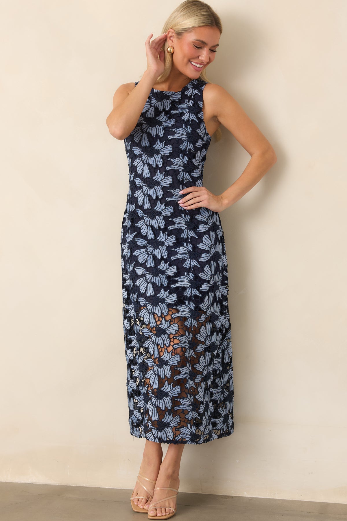 Navy-outlined floral dress featuring oversized light blue blooms, a shorter lining, and airy lace at the hem.