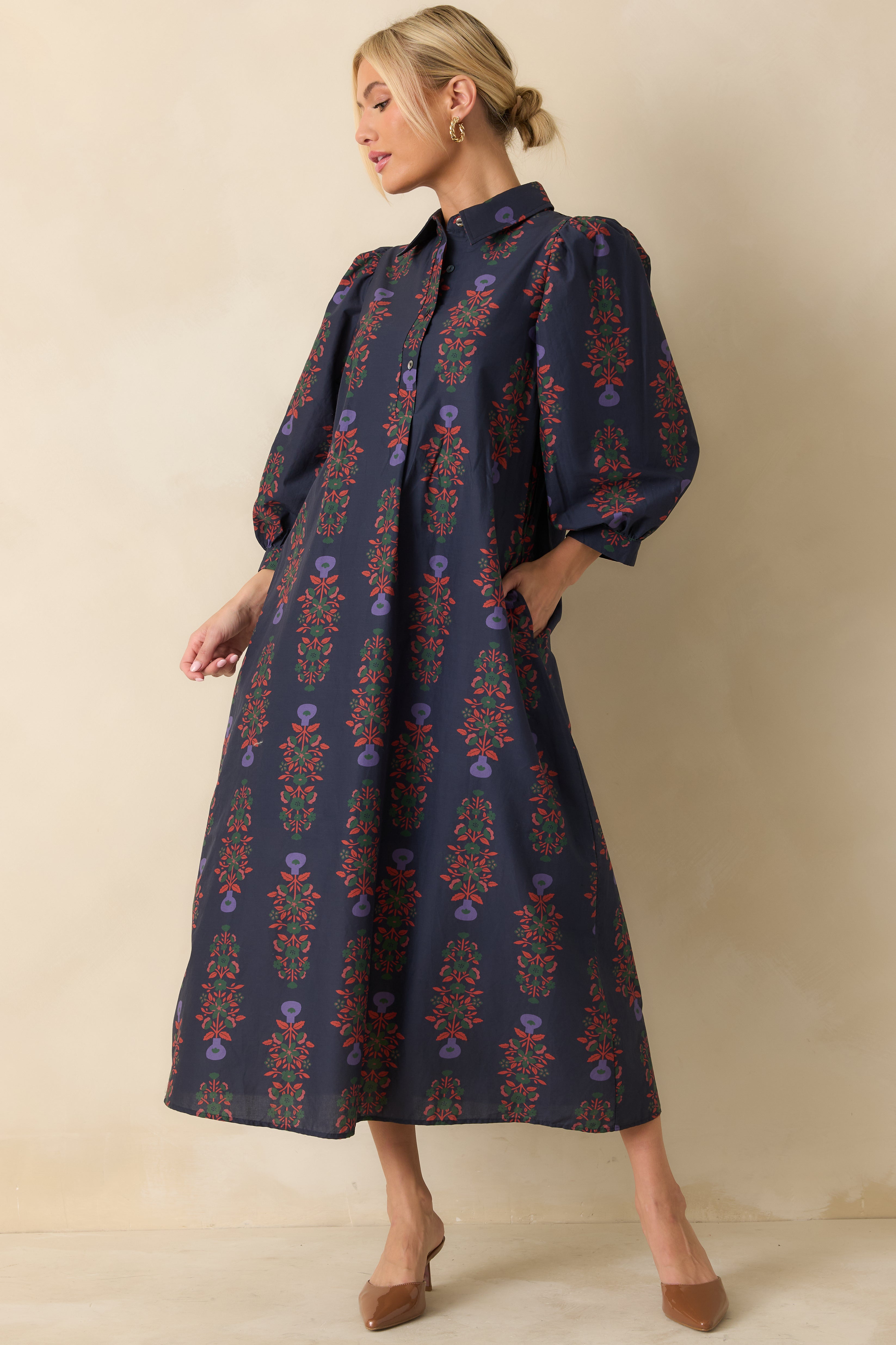 Flowy navy floral maxi dress with cinched waist and classic collared neckline.
