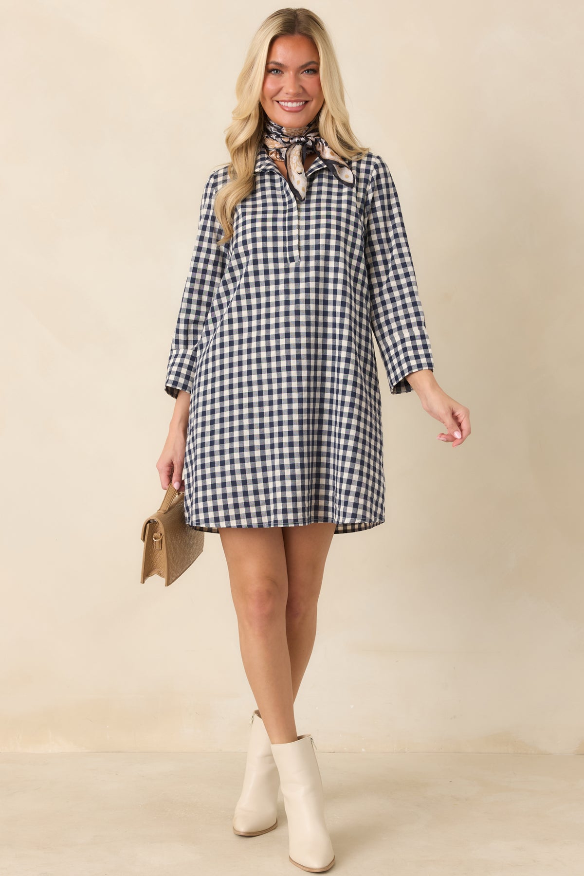 Structured cotton-blend gingham dress features a relaxed A-line shape with a polished collar and neatly finished hem.