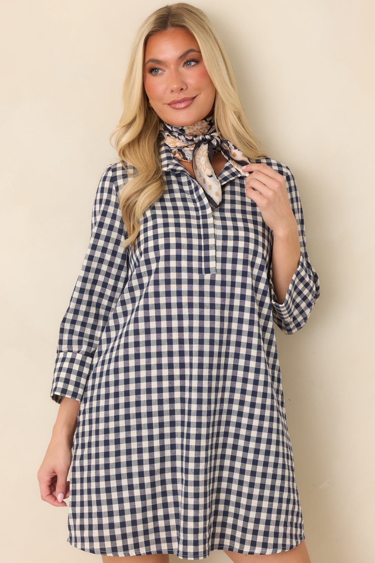Concealed partial button placket creates a clean front finish on the navy gingham dress.