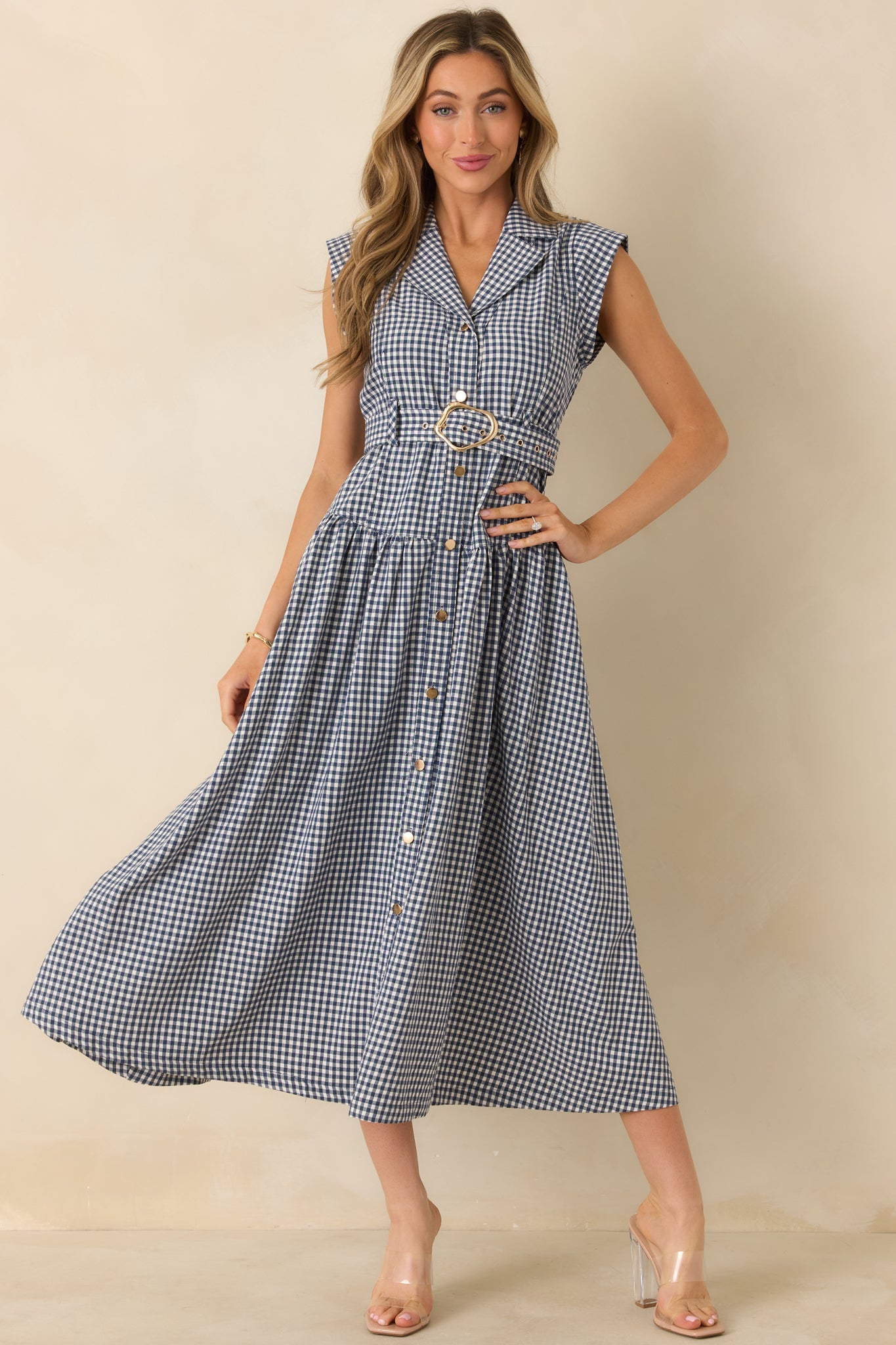 Navy gingham midi dress with a collared neckline, sleeveless design, and full button-front closure with matching buttons.