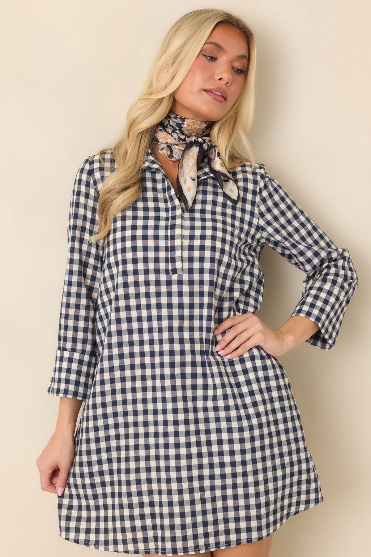 Navy and ivory gingham pattern frames the structured stand collar of this tailored mini dress.