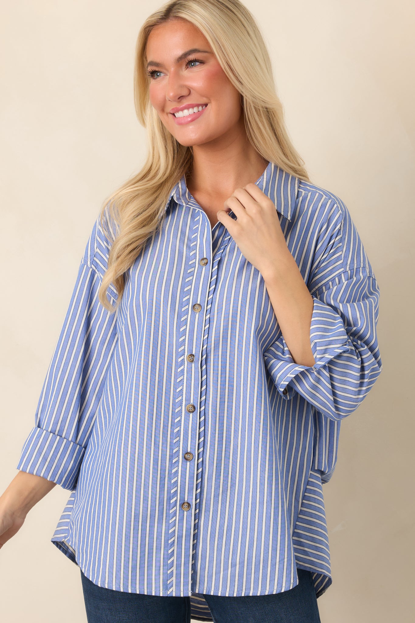 Navy striped shirt highlighting the ivory pattern, collared neckline, and neatly arranged button-front closure.