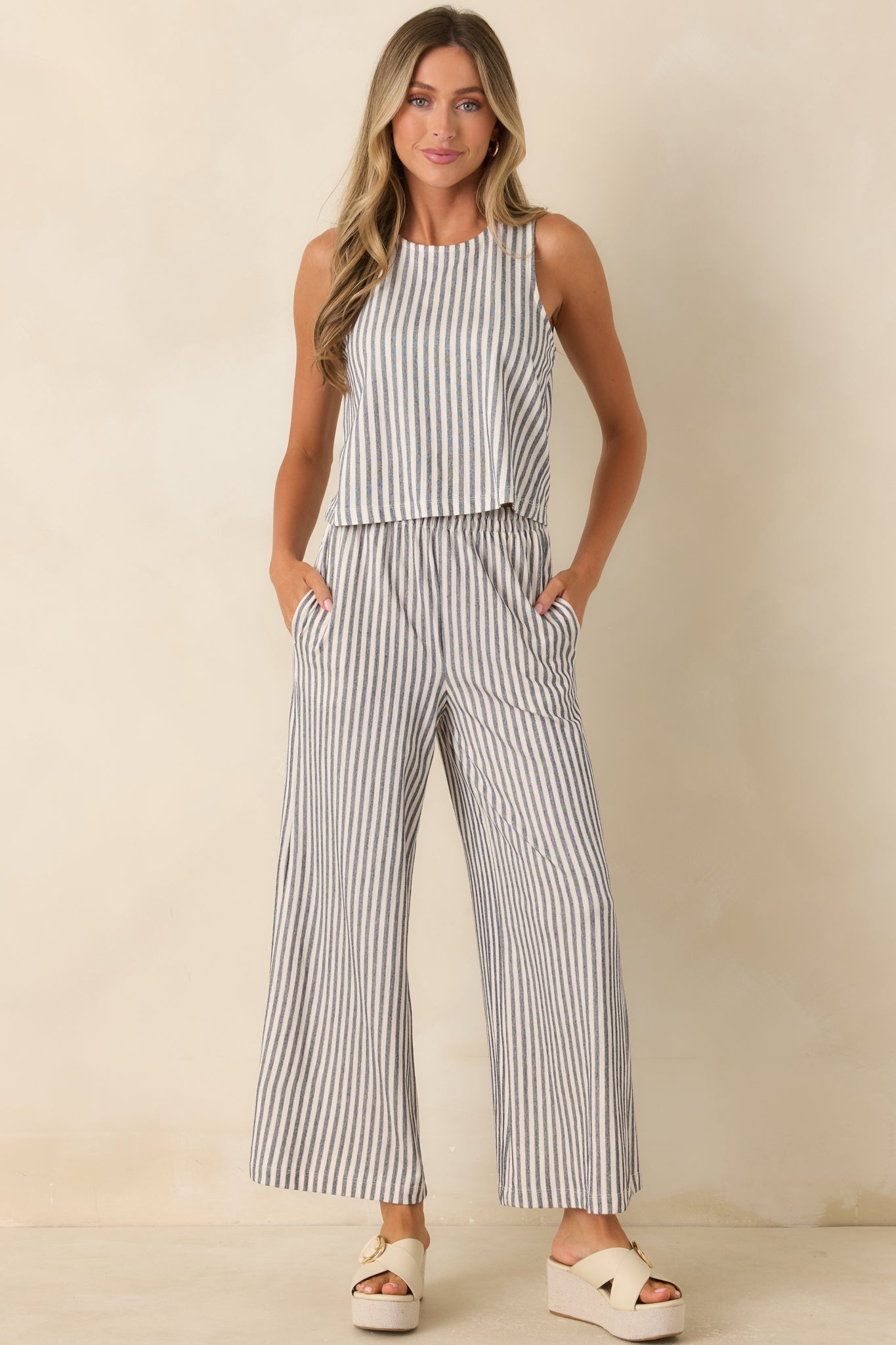 Navy and ivory striped cotton knit pants featuring a wide leg silhouette, elastic waistband, and side pockets.