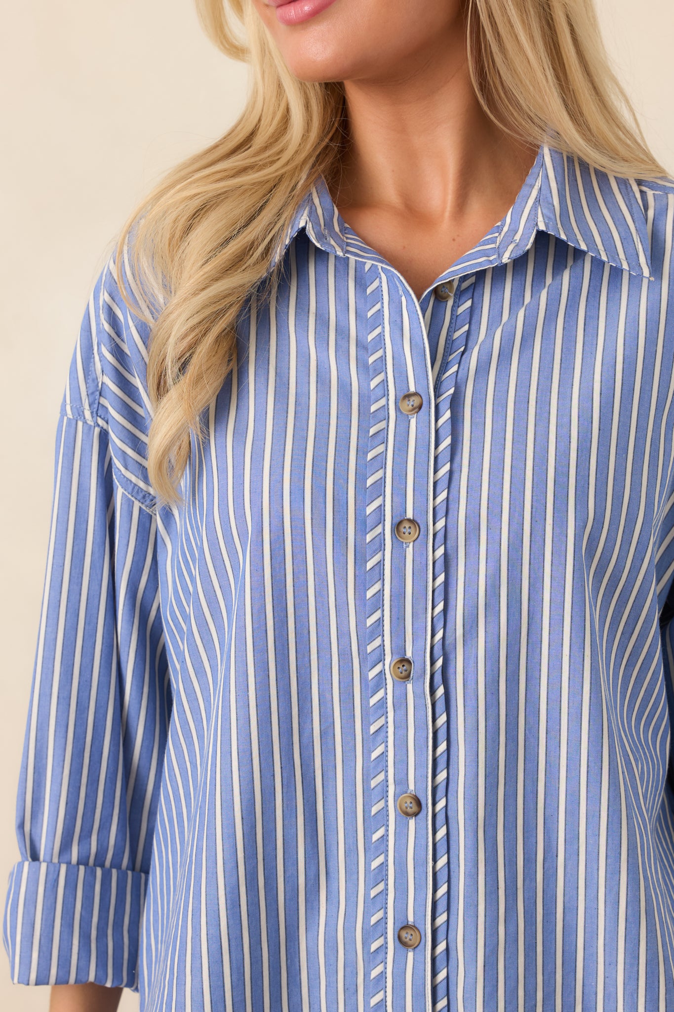 Close-up of the navy shirt revealing the contrasting ivory stripe pattern, classic collar, and smooth button-front construction.