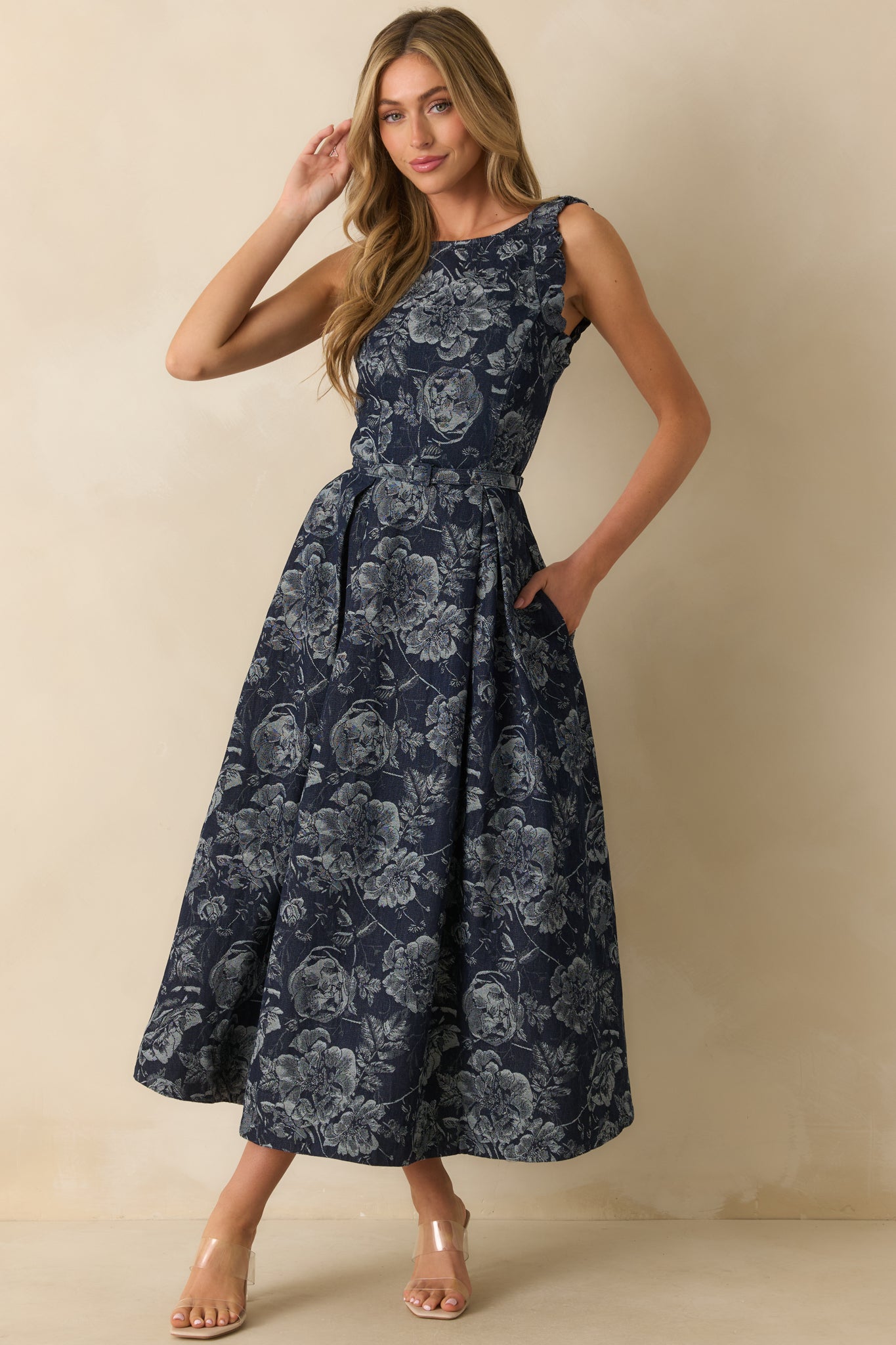 A full front view showing the pleated skirt and functional pockets on the navy jacquard dress.