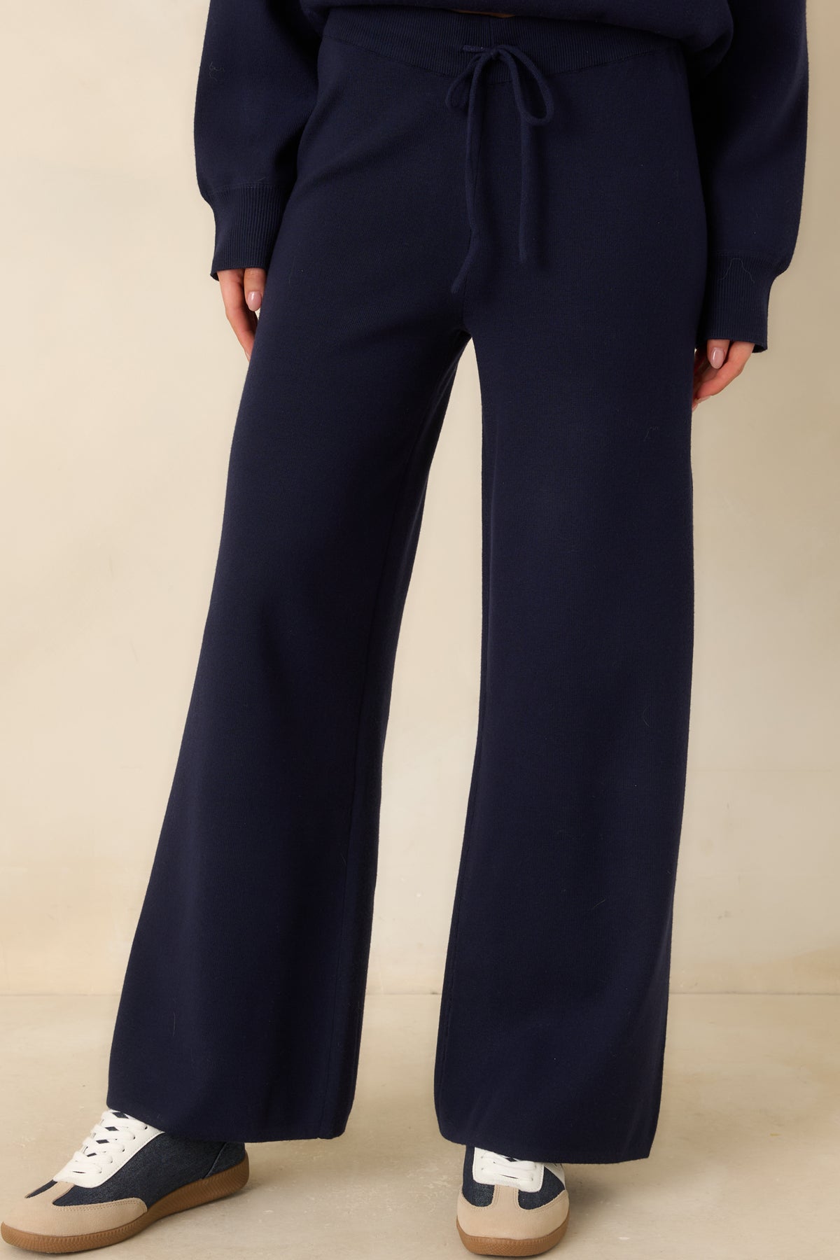High-rise elastic waistband with an adjustable drawcord on the deep navy knit pants.