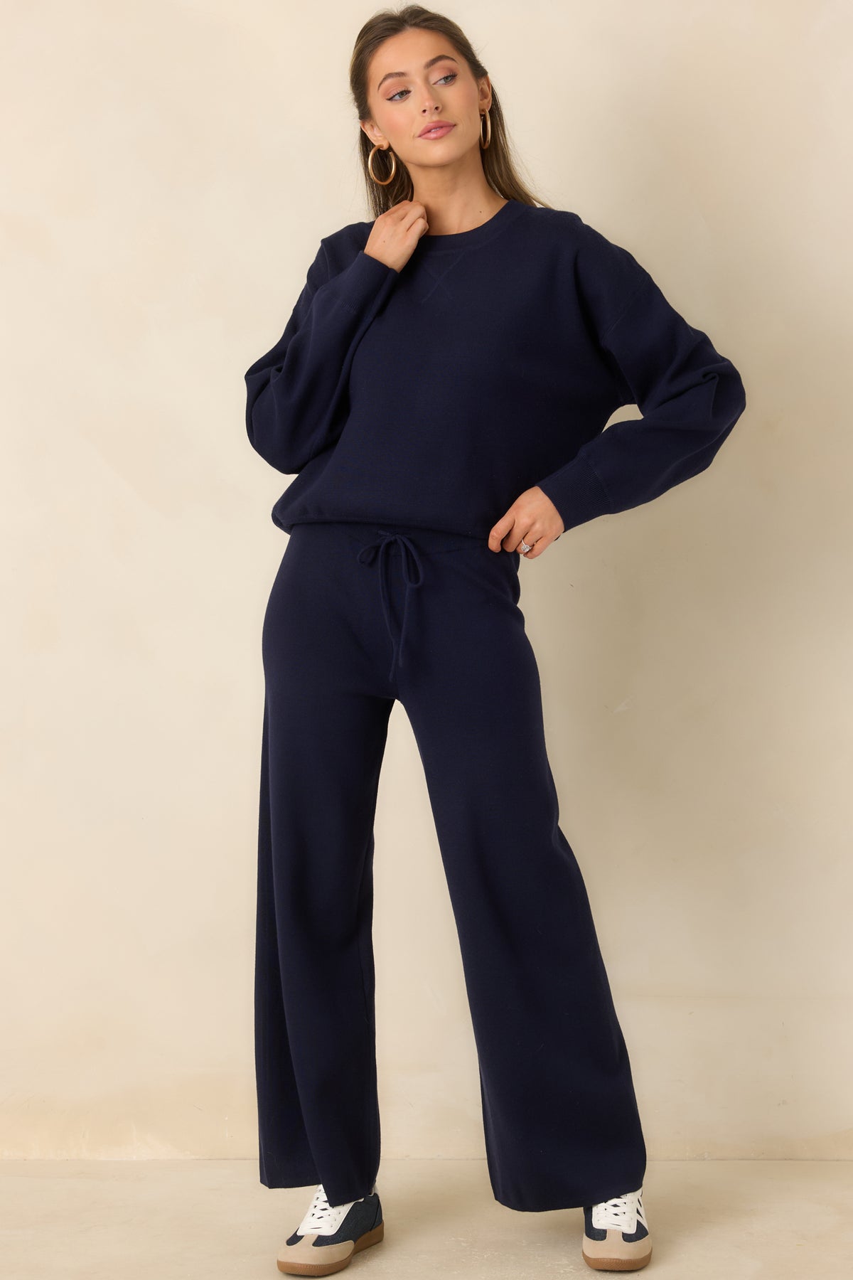 Relaxed navy knit pants featuring side seam pockets and an adjustable drawstring waistband.