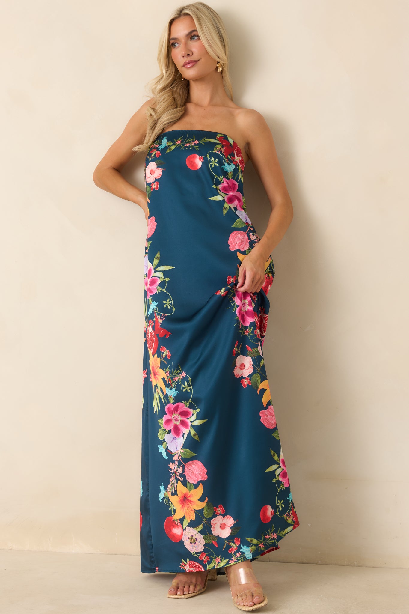 Vibrant navy maxi dress highlighting the detailed floral border print, concealed design elements, and effortless warm-weather style.