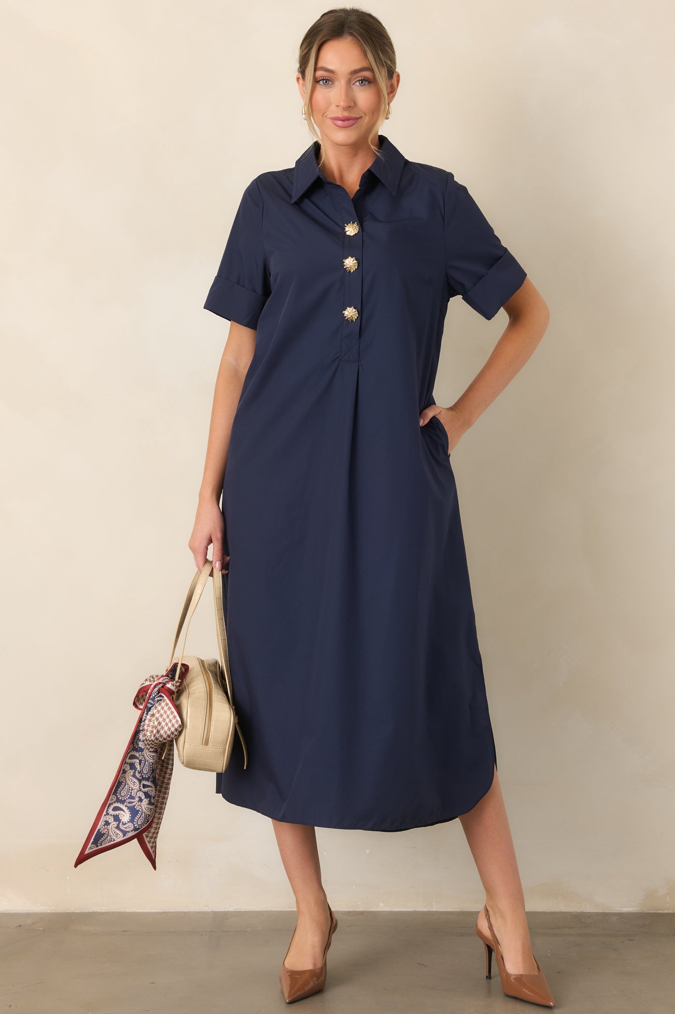 Rich navy maxi dress showcasing the partial button-front placket, rolled sleeves, and softly flowing A-line shape.