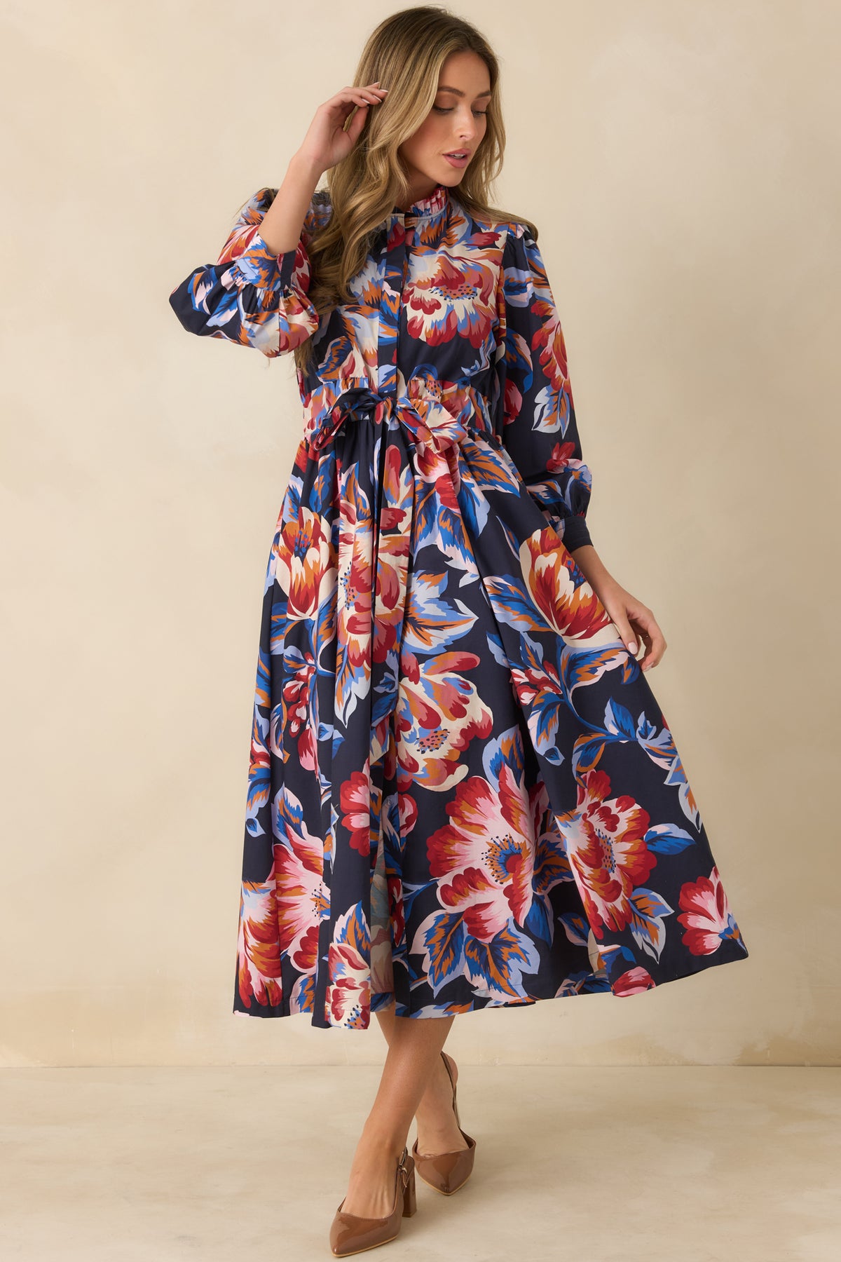 Romantic cotton midi dress showcasing oversized florals, an adjustable waist tie, and a ruffled stand neckline.