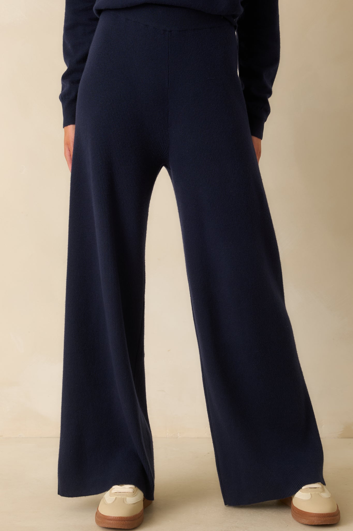 Front view of the navy pants emphasizing the comfortable elastic waistband and flowy leg line.
