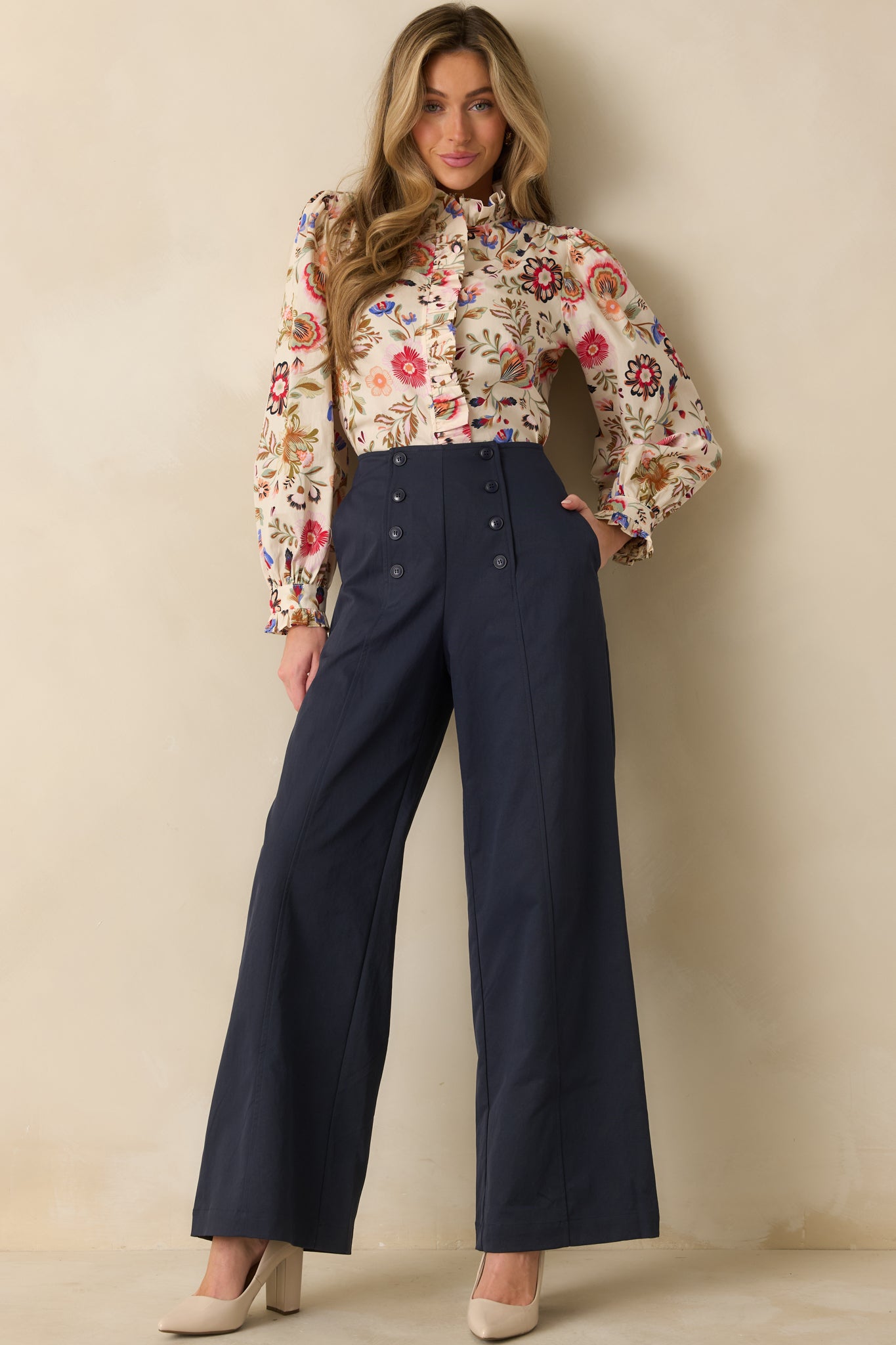 Navy pants featuring full-length wide legs, functional front buttons, and a tailored yet lightweight design.
