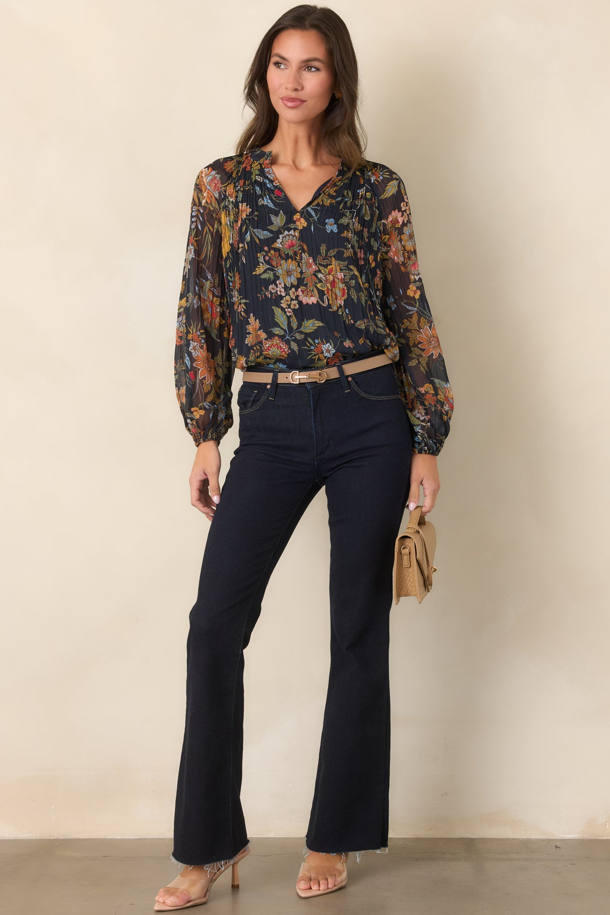Pleated botanical top with a deep navy base, softly gathered neckline, and sheer balloon sleeves.
