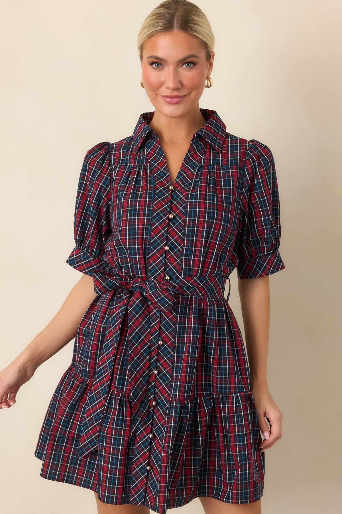 Navy and red plaid mini dress with softly gathered sleeves and a tiered skirt.