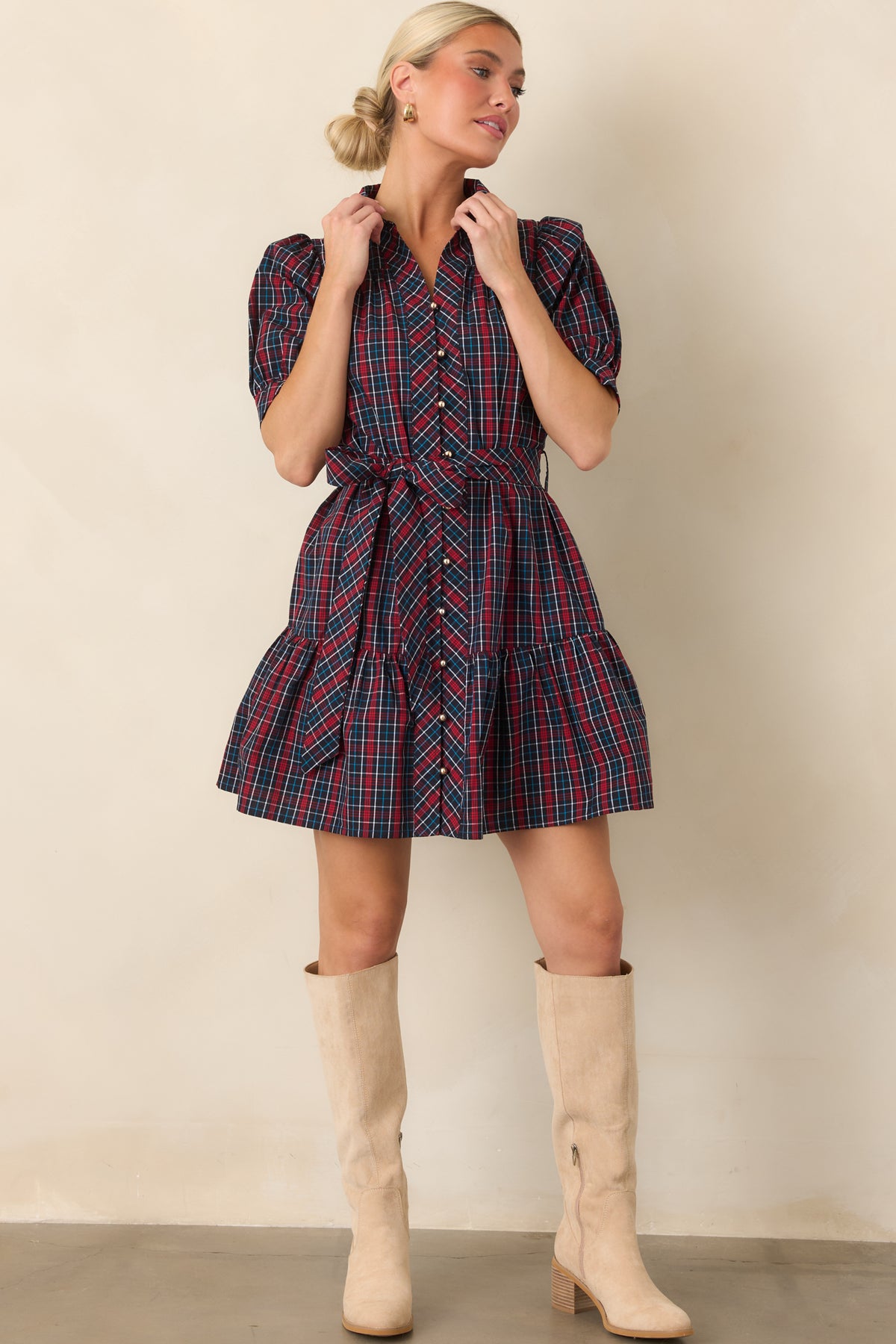 Rich navy and red plaid mini dress with functional gold-tone buttons, a defined waist, and lively tiered skirt.
