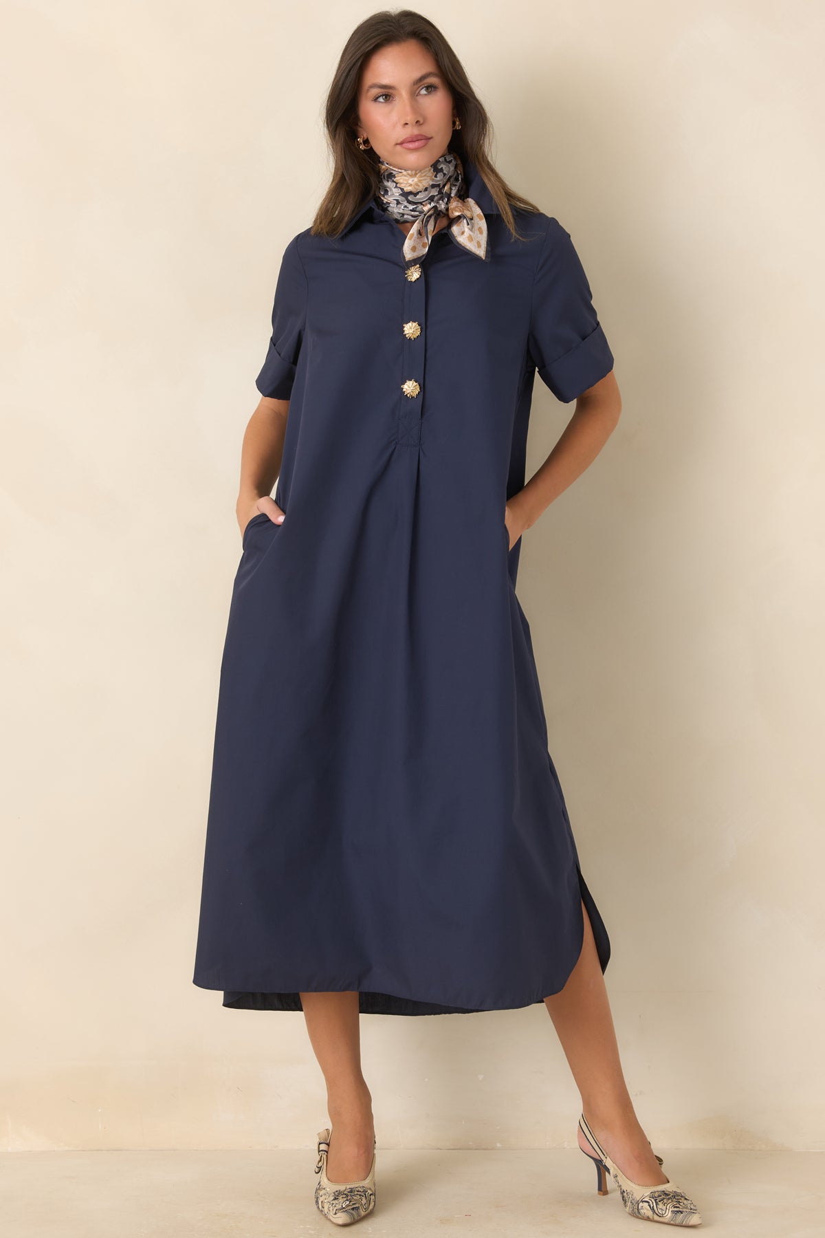 Relaxed navy maxi dress with rolled short sleeves, a classic collar, side slits, and flowing A-line shape.
