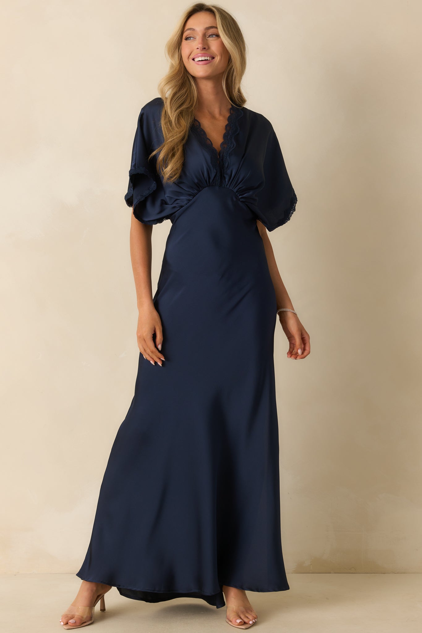 Satin navy maxi dress with a hidden side zipper and elegant drape.