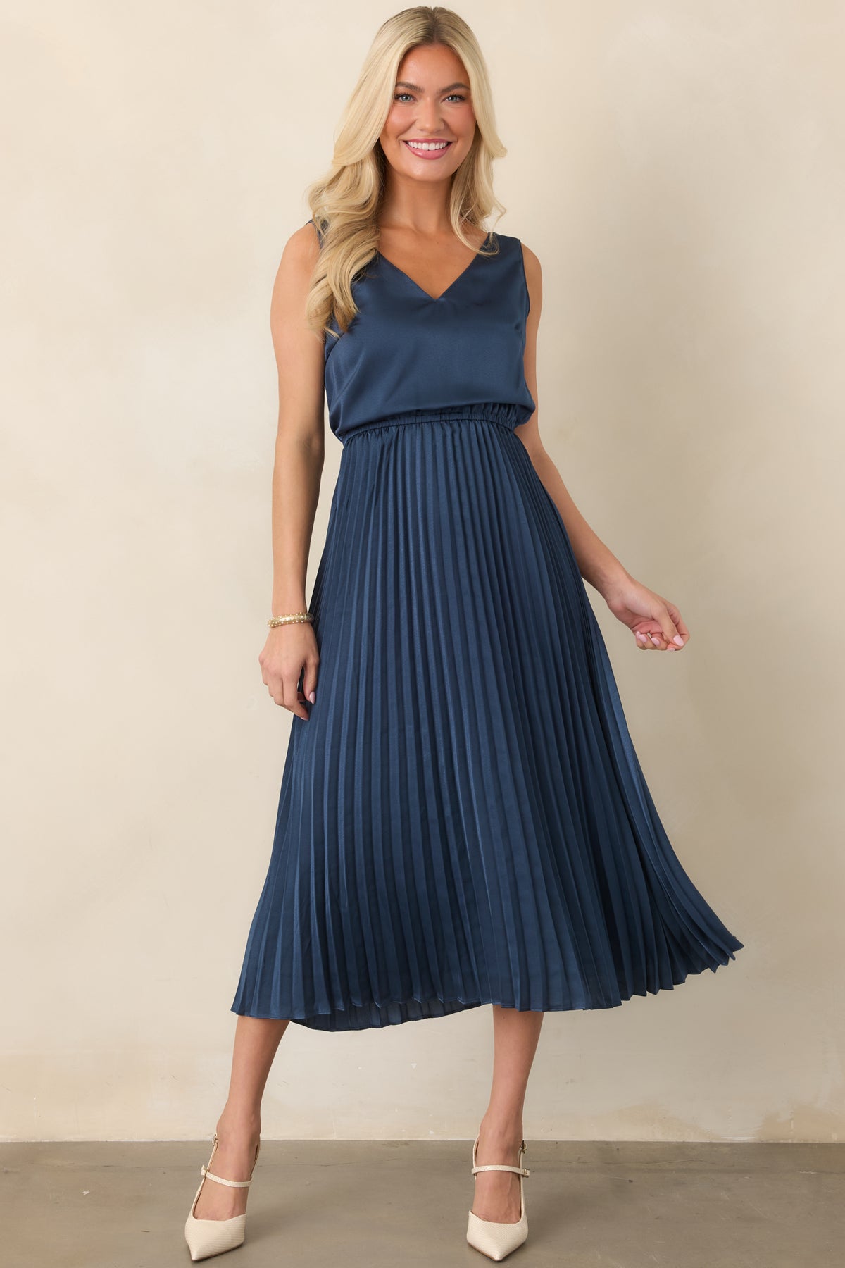 Navy set showcasing the ribbed crew-neck sweater layered with a V-neck satin midi dress and elastic waist.