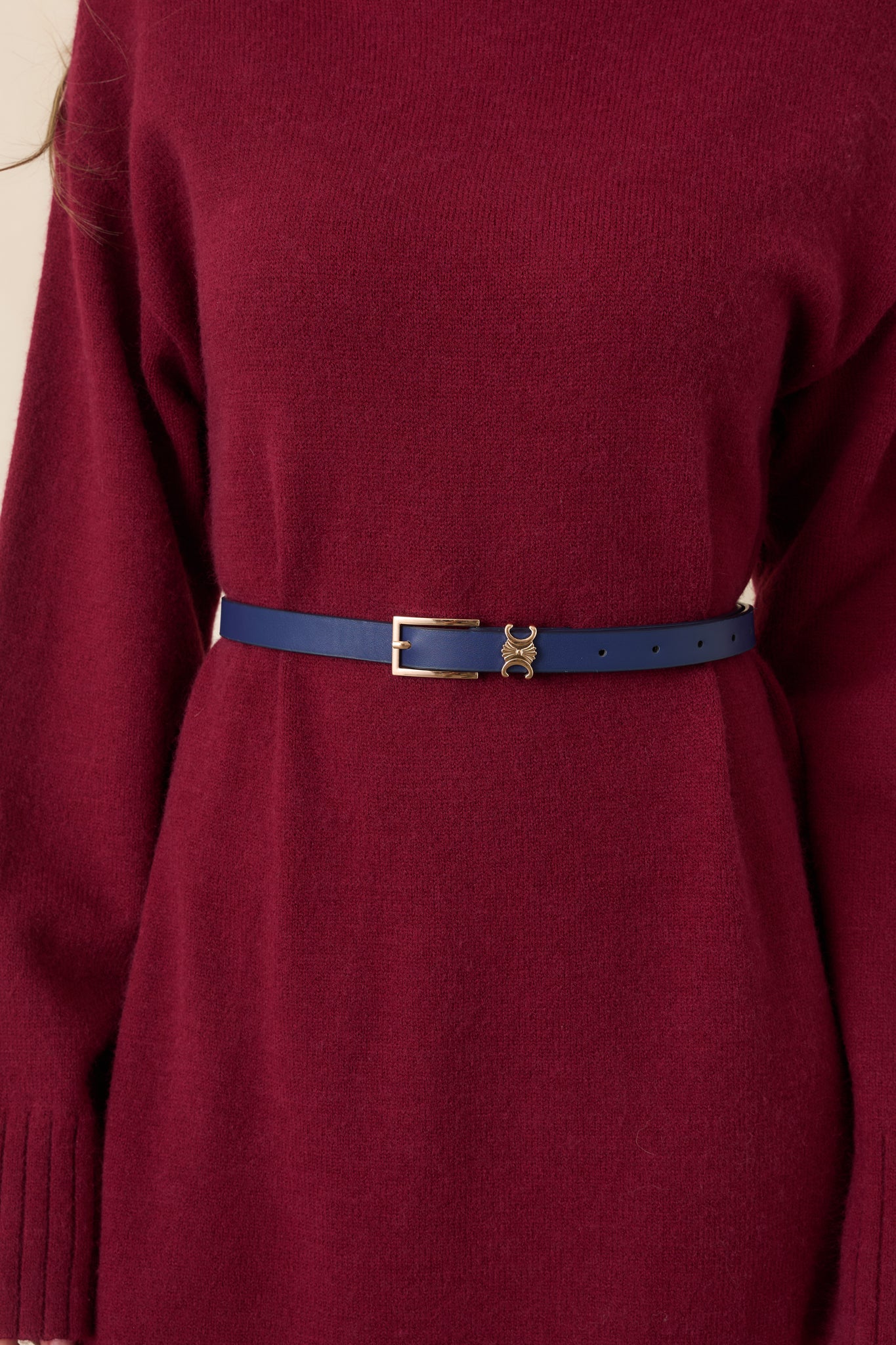 Navy slim belt crafted from smooth faux leather with a sleek gold-tone buckle.