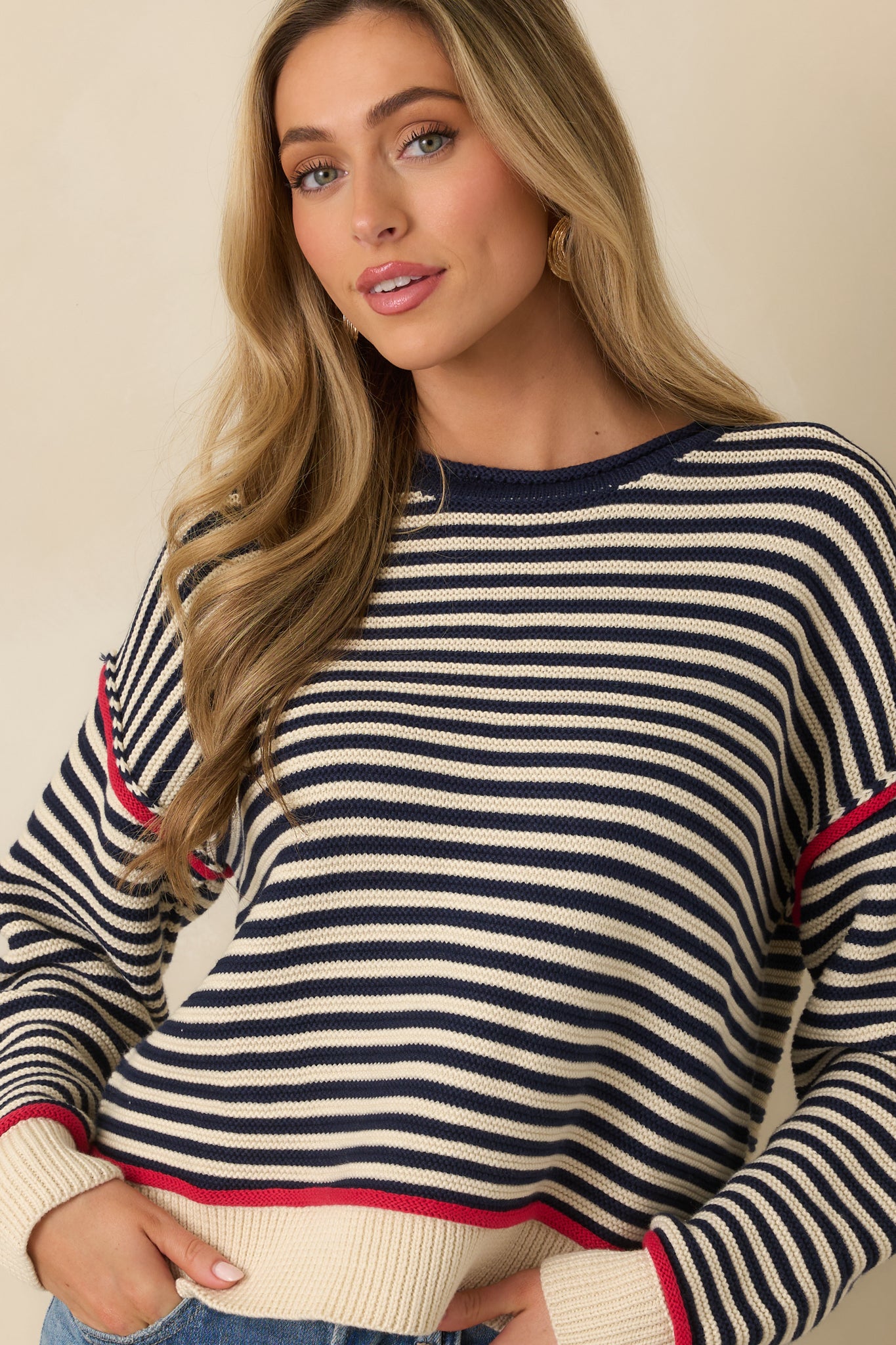 Navy stripe crewneck sweater emphasizing the ribbed neckline and contrast trim along the collar.
