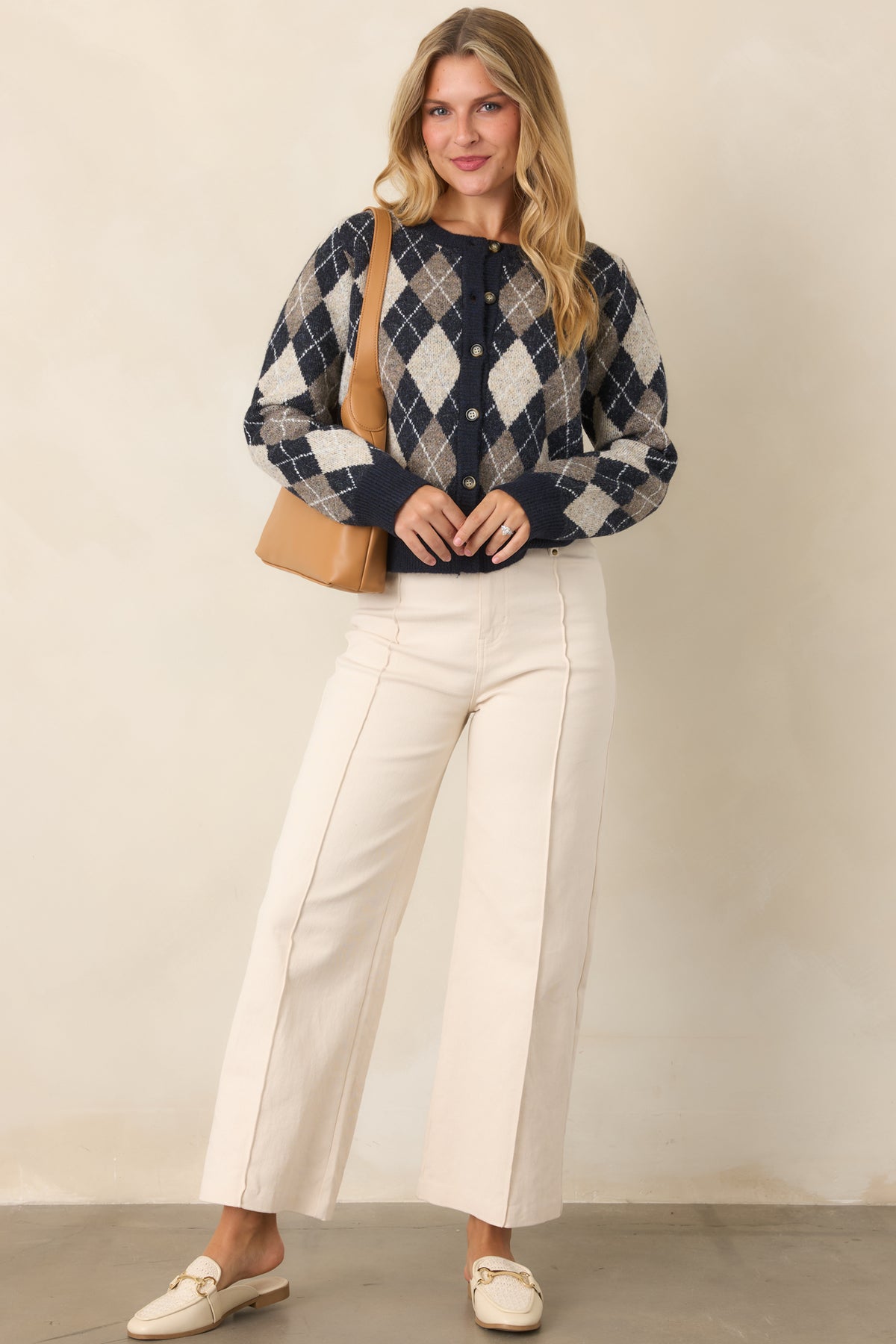 Navy and taupe diamond cardigan with ivory accents, long sleeves, coordinating trim, and a relaxed silhouette.