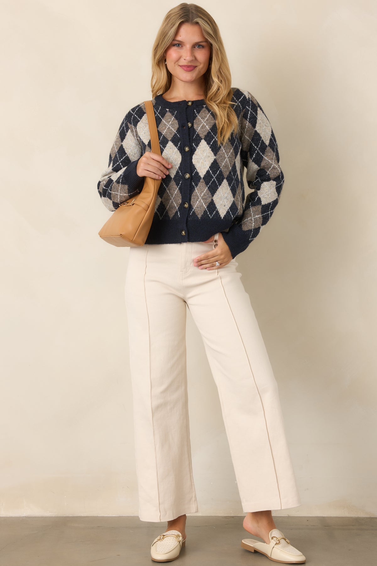 Deep navy, warm taupe, and ivory cardigan featuring a diamond pattern with fine white lines and a ribbed crew neckline.