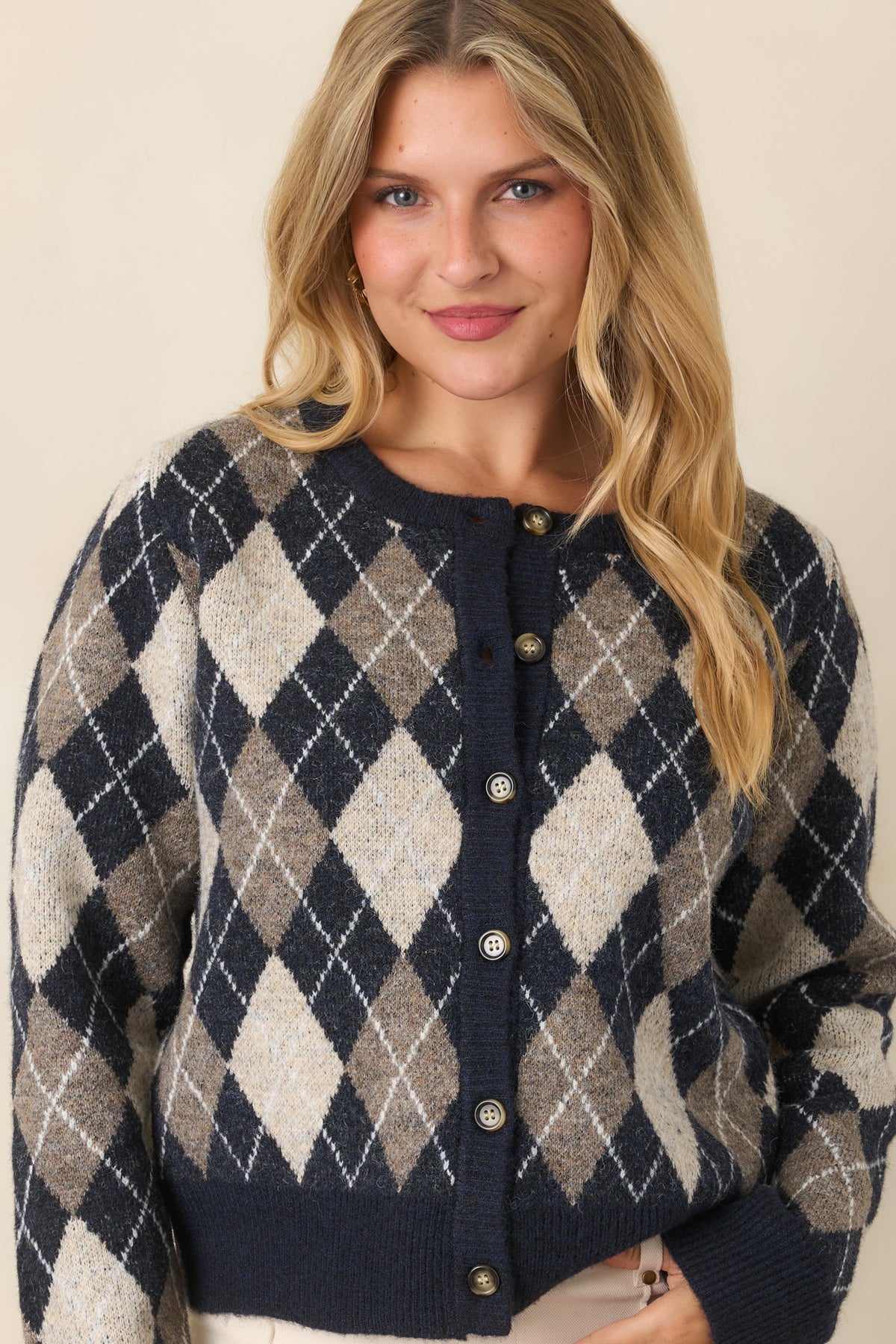 Navy, taupe, and ivory diamond knit cardigan showcasing the button-front closure and coordinating navy trim.