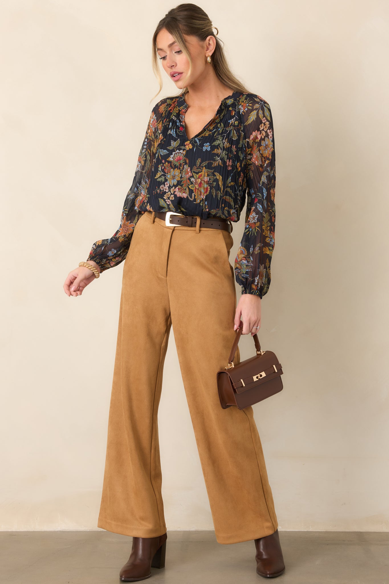 Navy printed top with softly gathered ruffle neckline detailing, sheer balloon sleeves, and elasticized cuffs.
