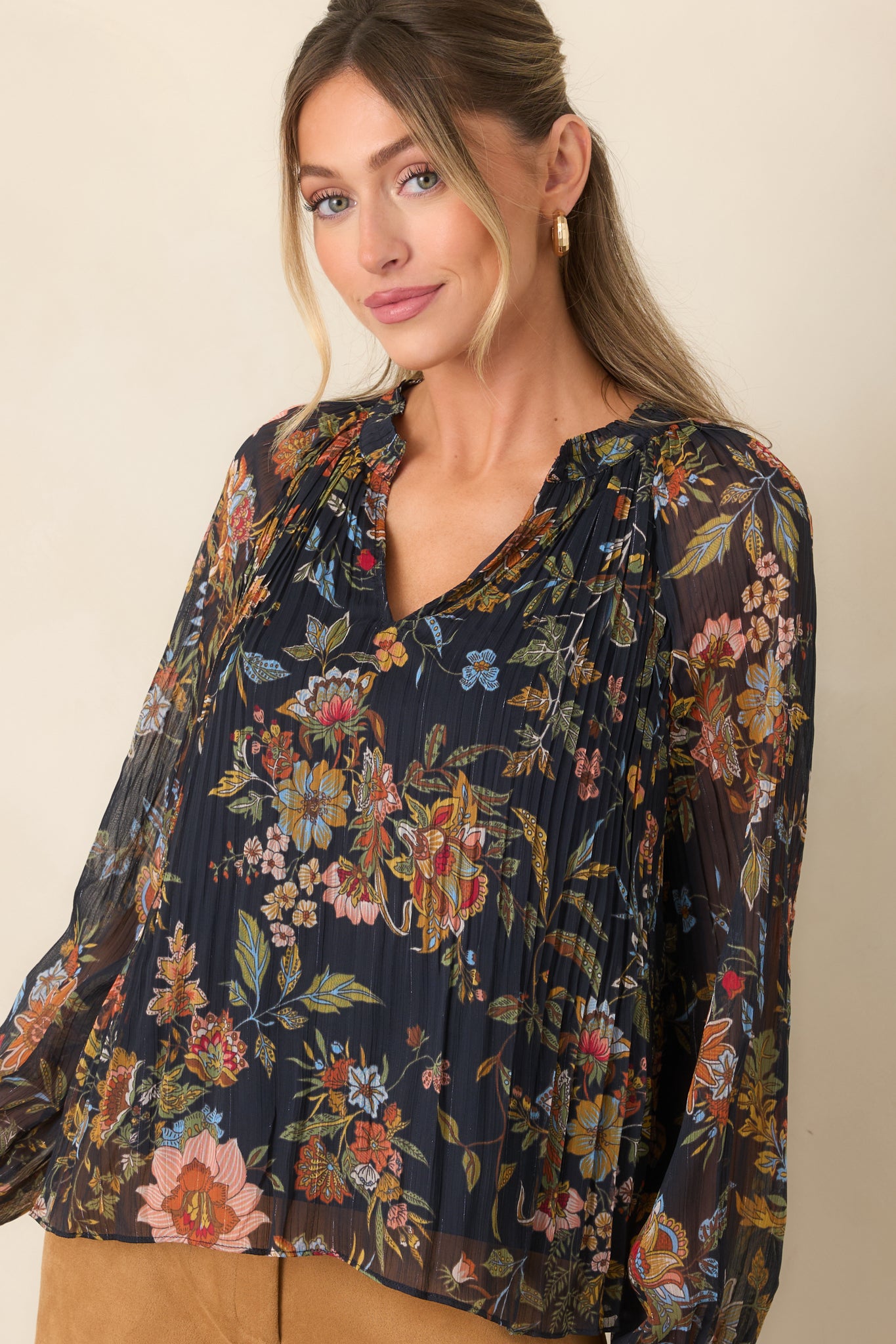 Sheer balloon sleeve showcasing its lightweight texture and elasticized cuff against the colorful botanical print.