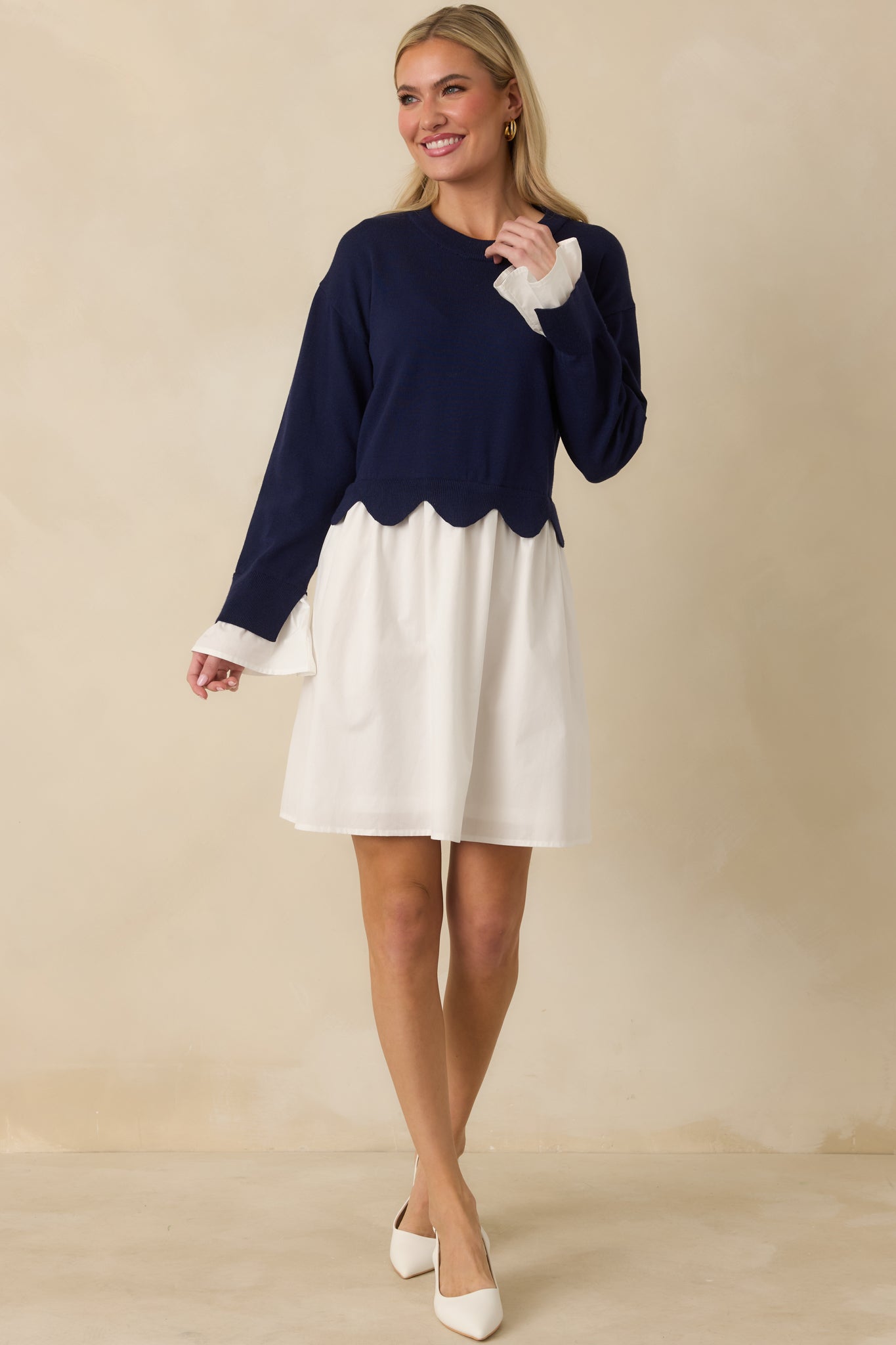 Relaxed navy and white mini dress showcasing a scalloped waist seam and softly flowing woven skirt.