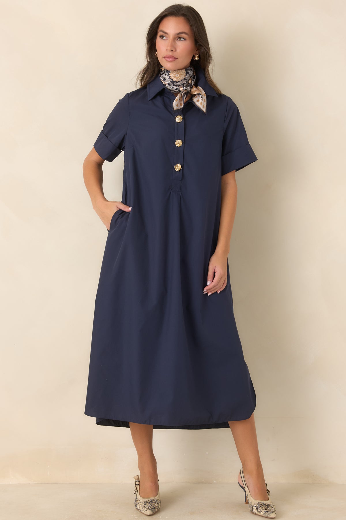 Rich navy woven maxi dress with a collared neckline, gold floral buttons, rolled short sleeves, and relaxed A-line silhouette.