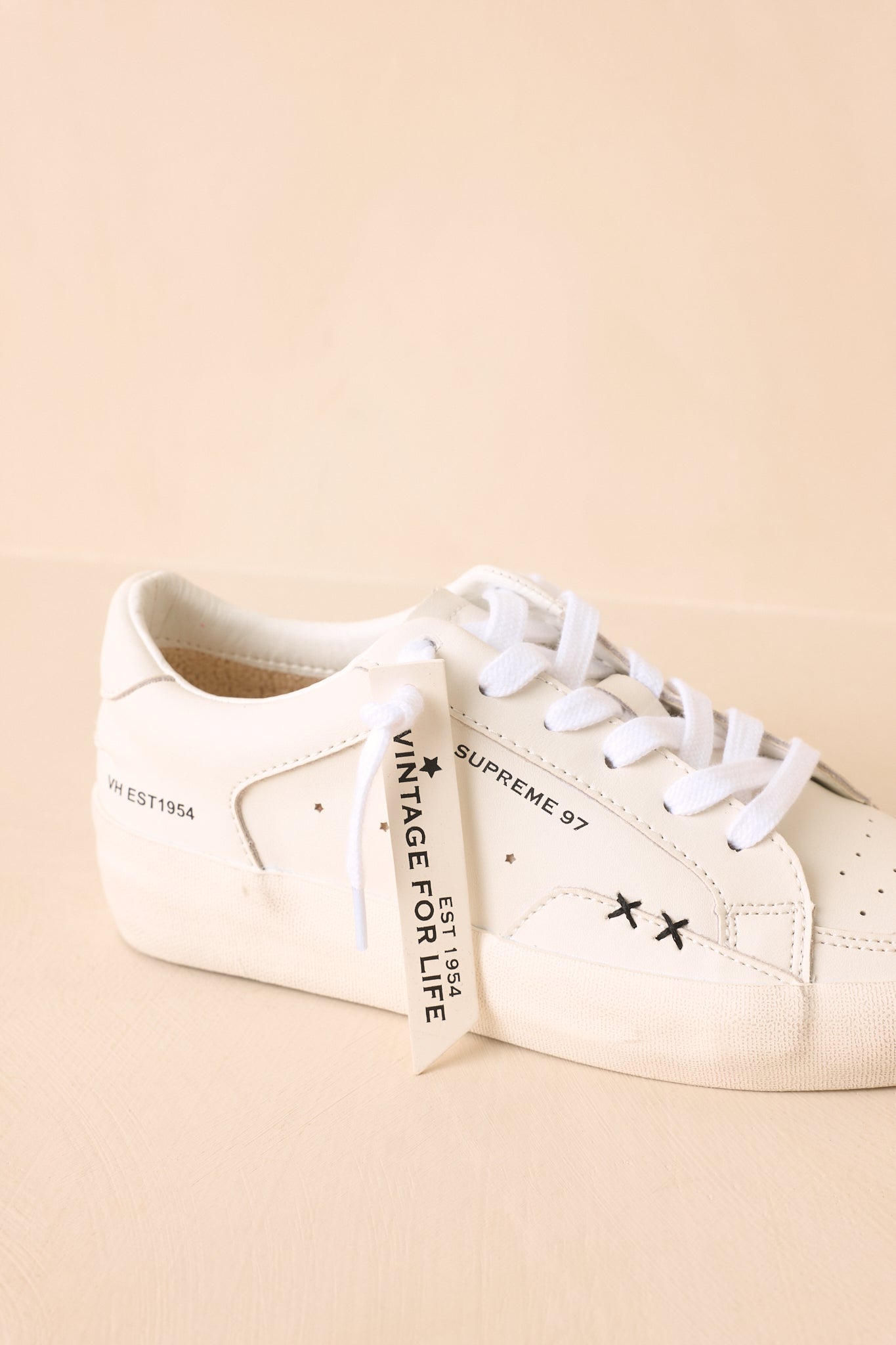 Close-up of neutral sneakers highlighting the refined texture, streamlined construction, and comfortable cushioned sole design.