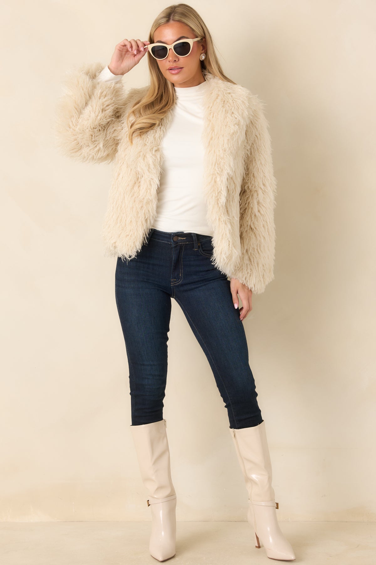 Neutral-colored jacket with a long-sleeved design, thick wavy texture, and versatile hip-length cut.