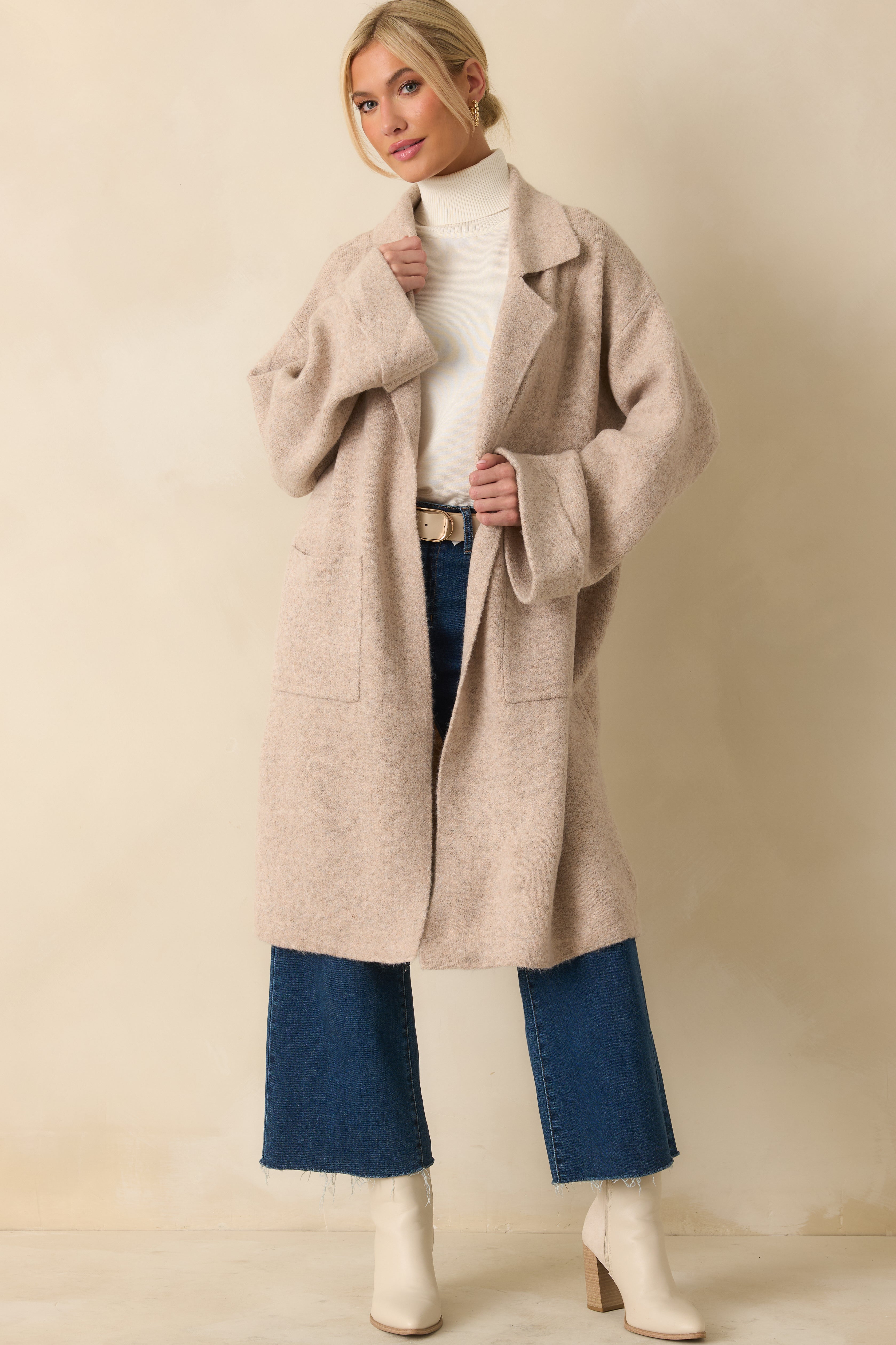 Oatmeal knit longline cardigan with an open-front design and relaxed, below-the-knee silhouette.