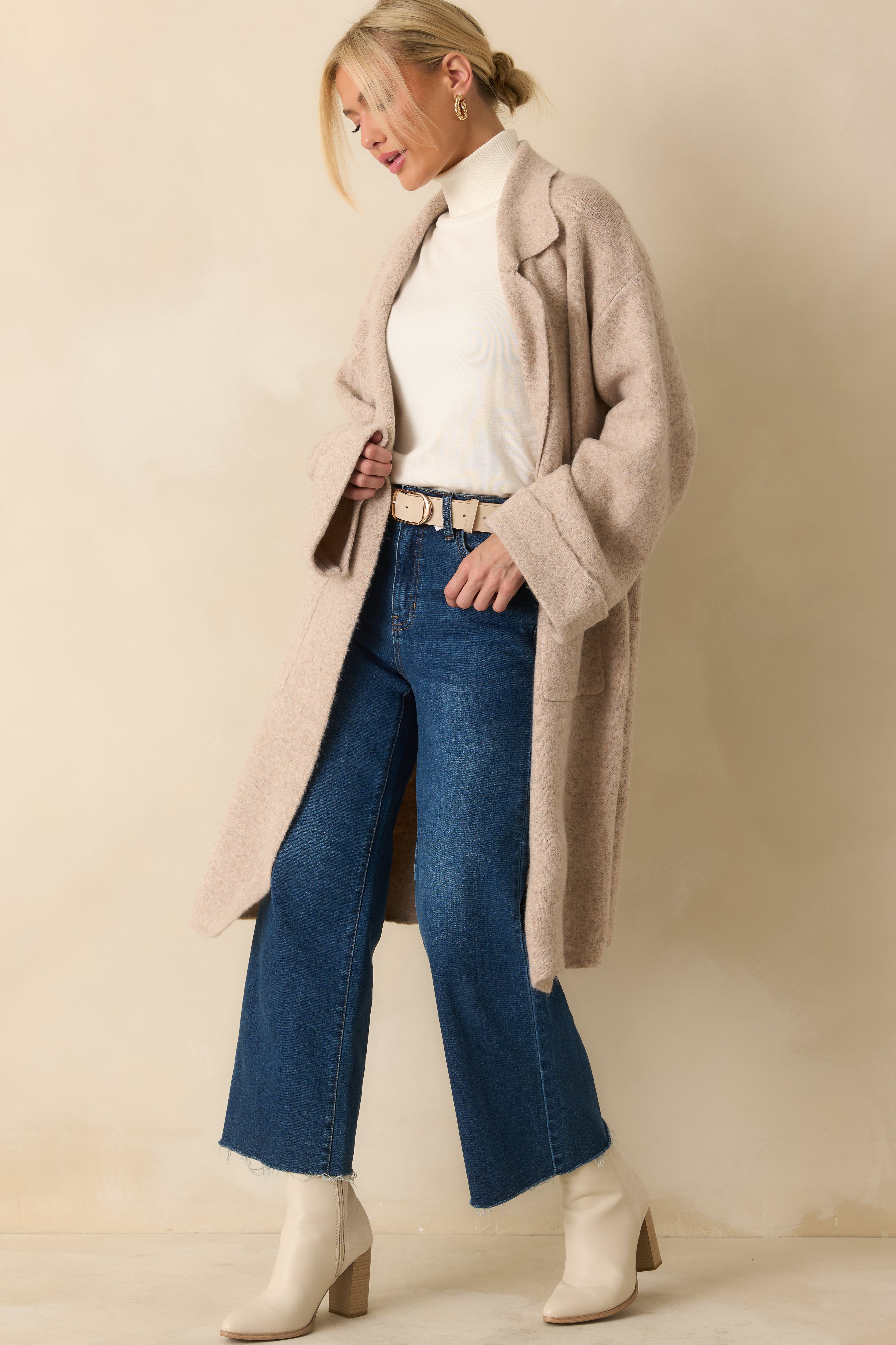 Oatmeal knit longline cardigan styled open to show the soft drape and oversized patch pockets.

