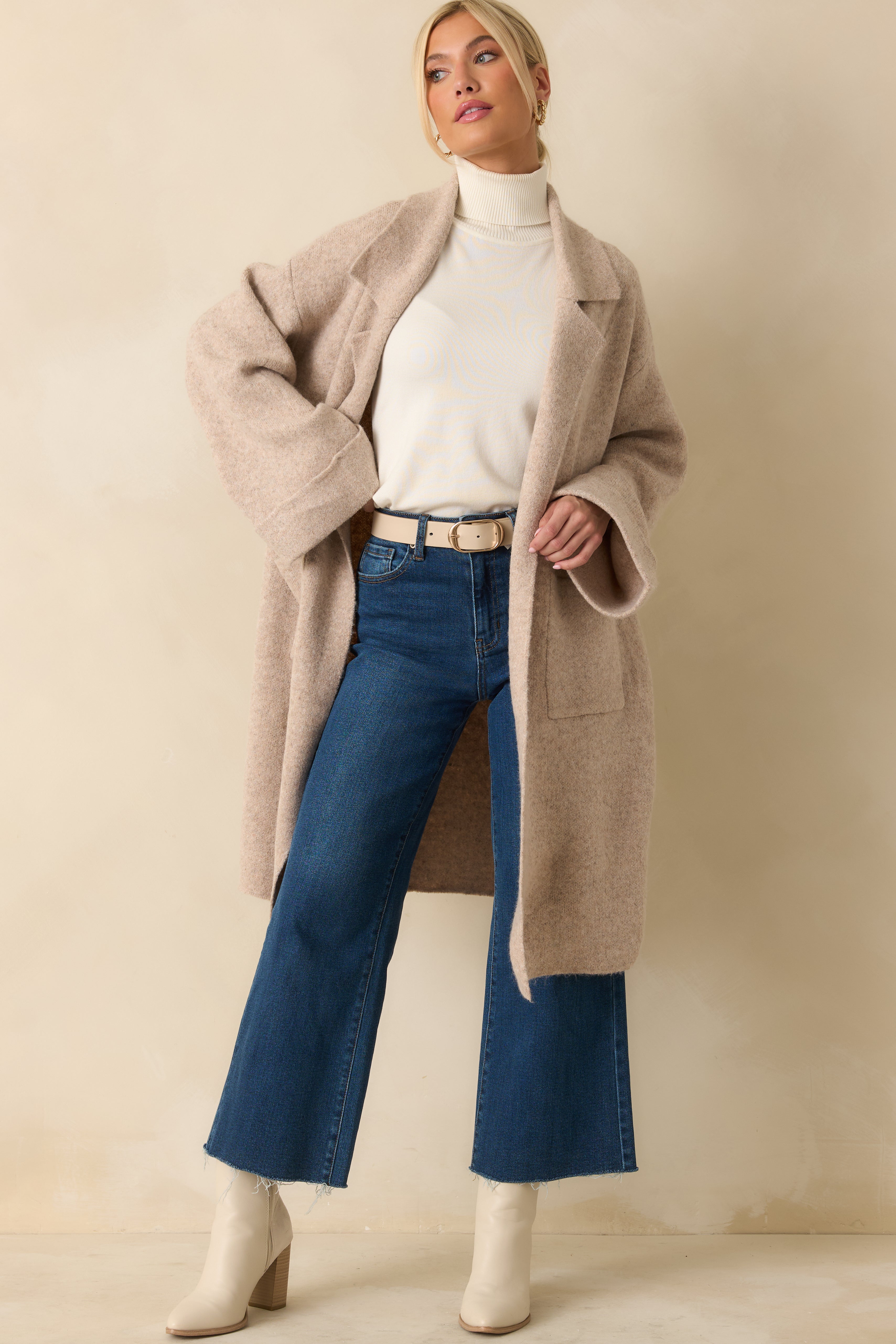 Longline cardigan in oatmeal tones showcasing drop-shoulder sleeves and large front patch pockets.