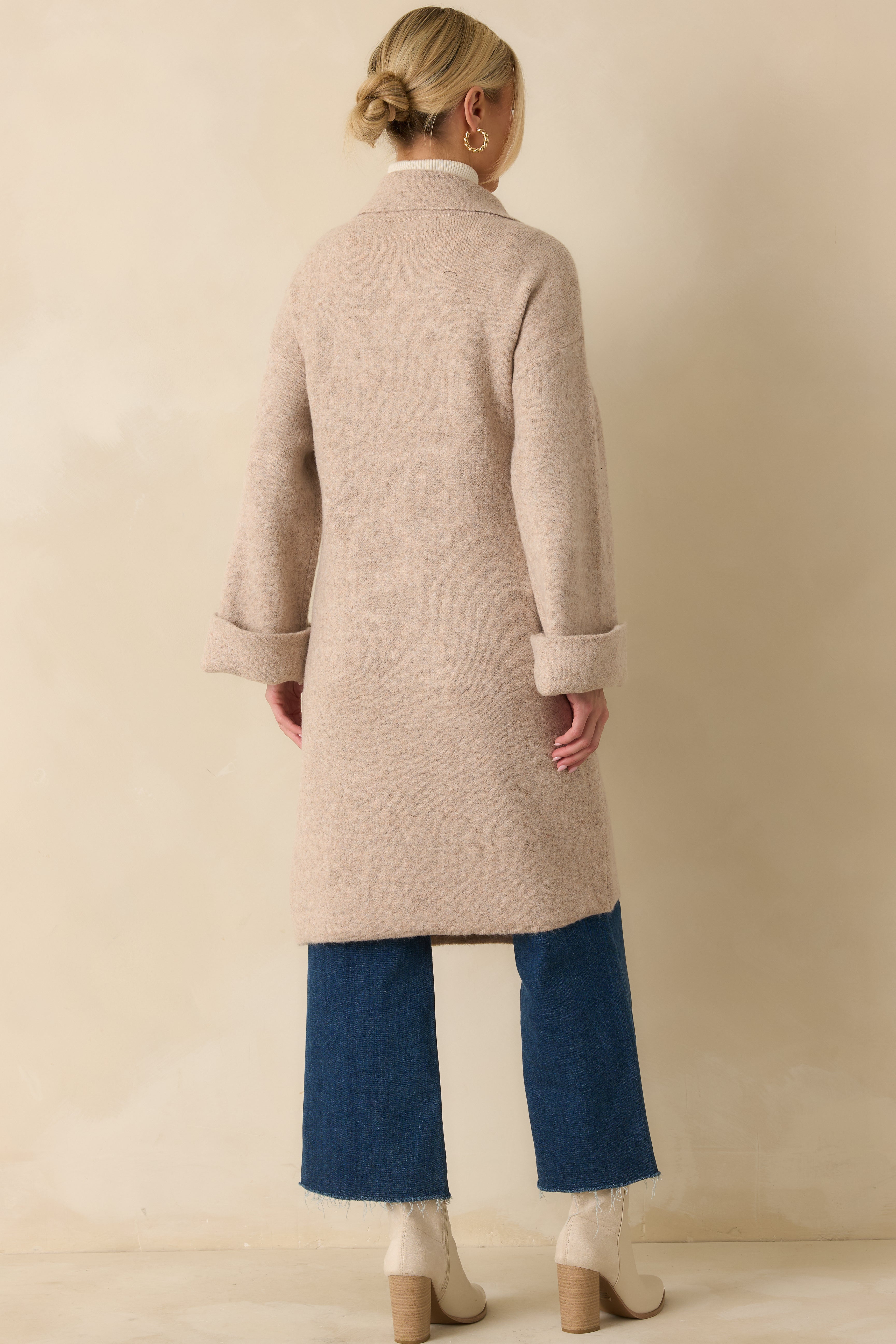 Rear view of the oatmeal longline cardigan showing the relaxed fit and flowing knit finish.